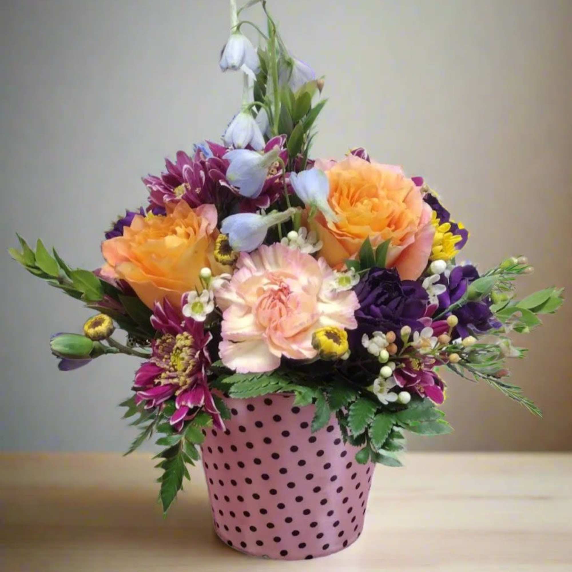Pail of Posies is a charming floral arrangement presented in a delightful