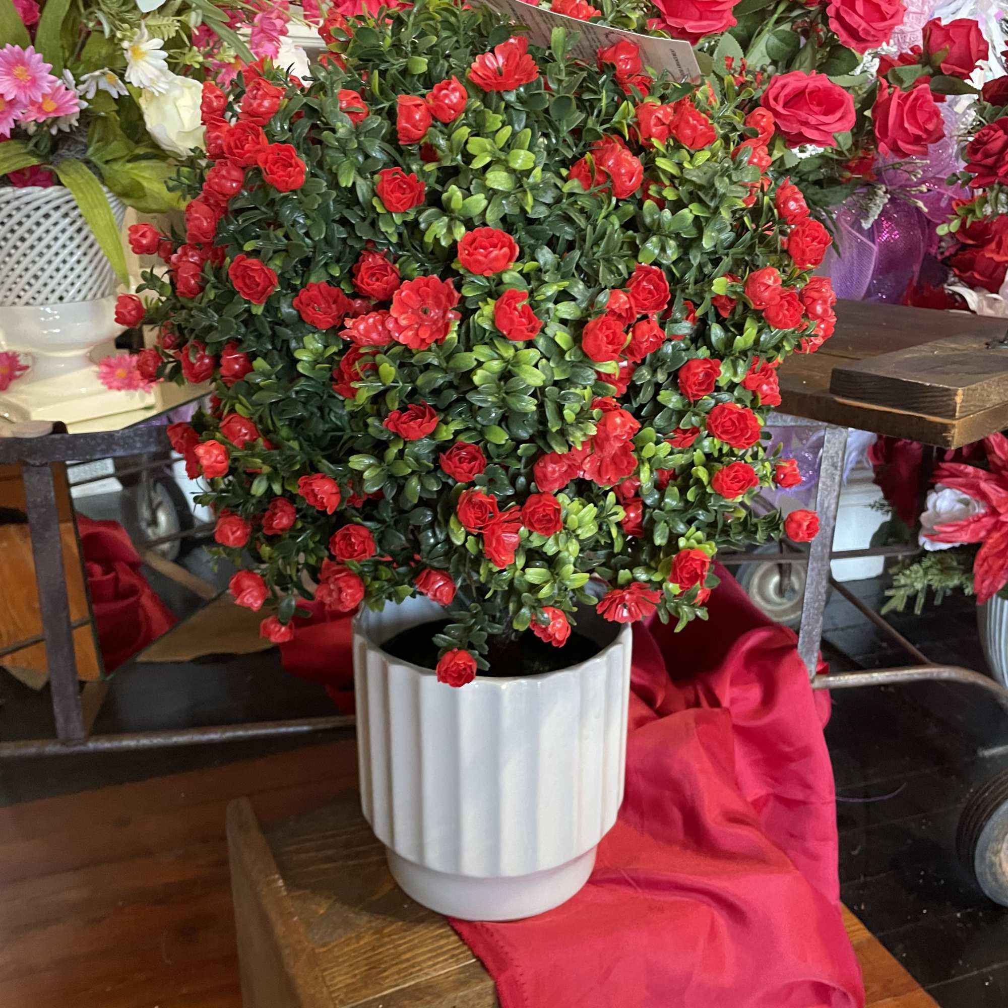 Brighten up a space with this lovely SILK  red rose bush