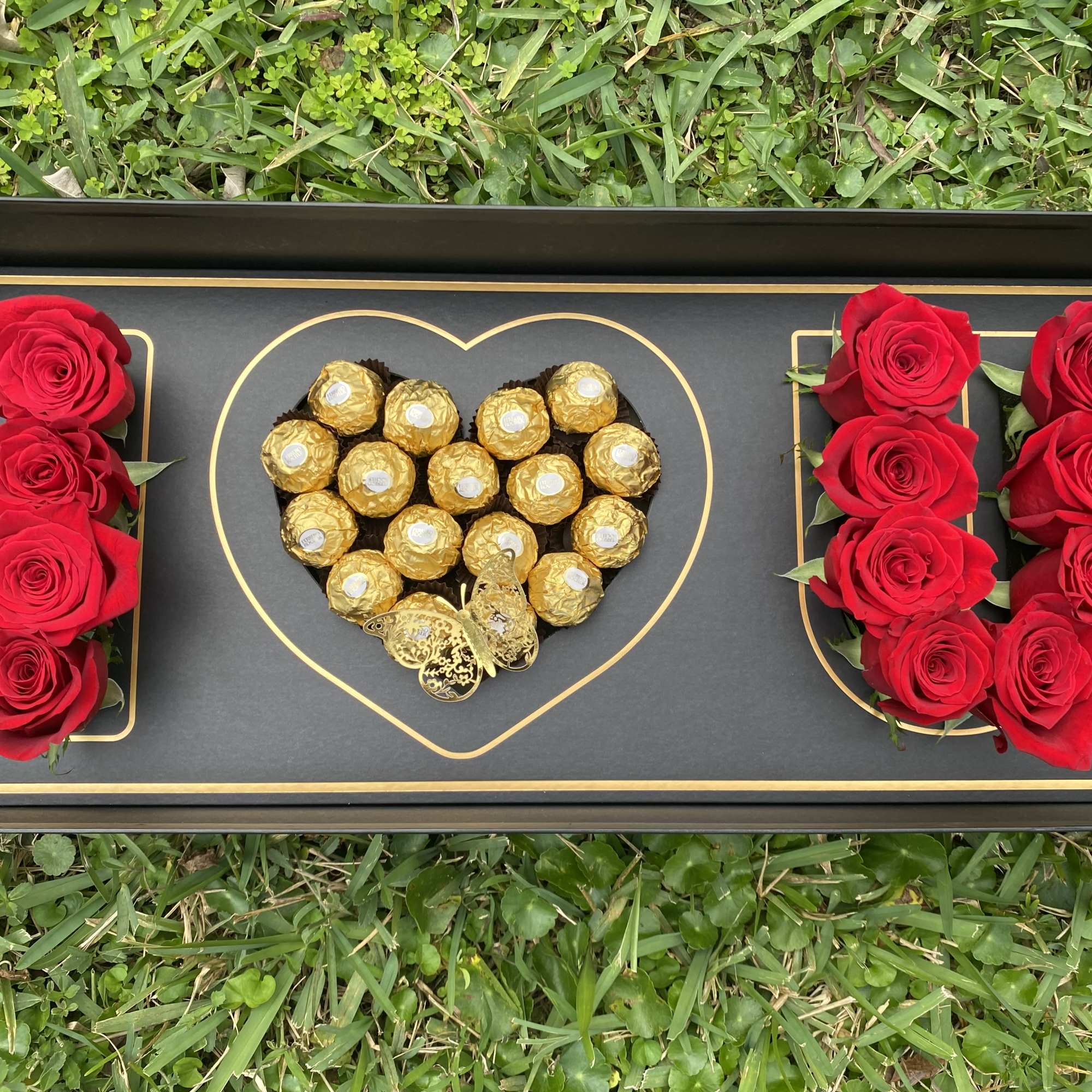 Box with roses and heart chocolate
