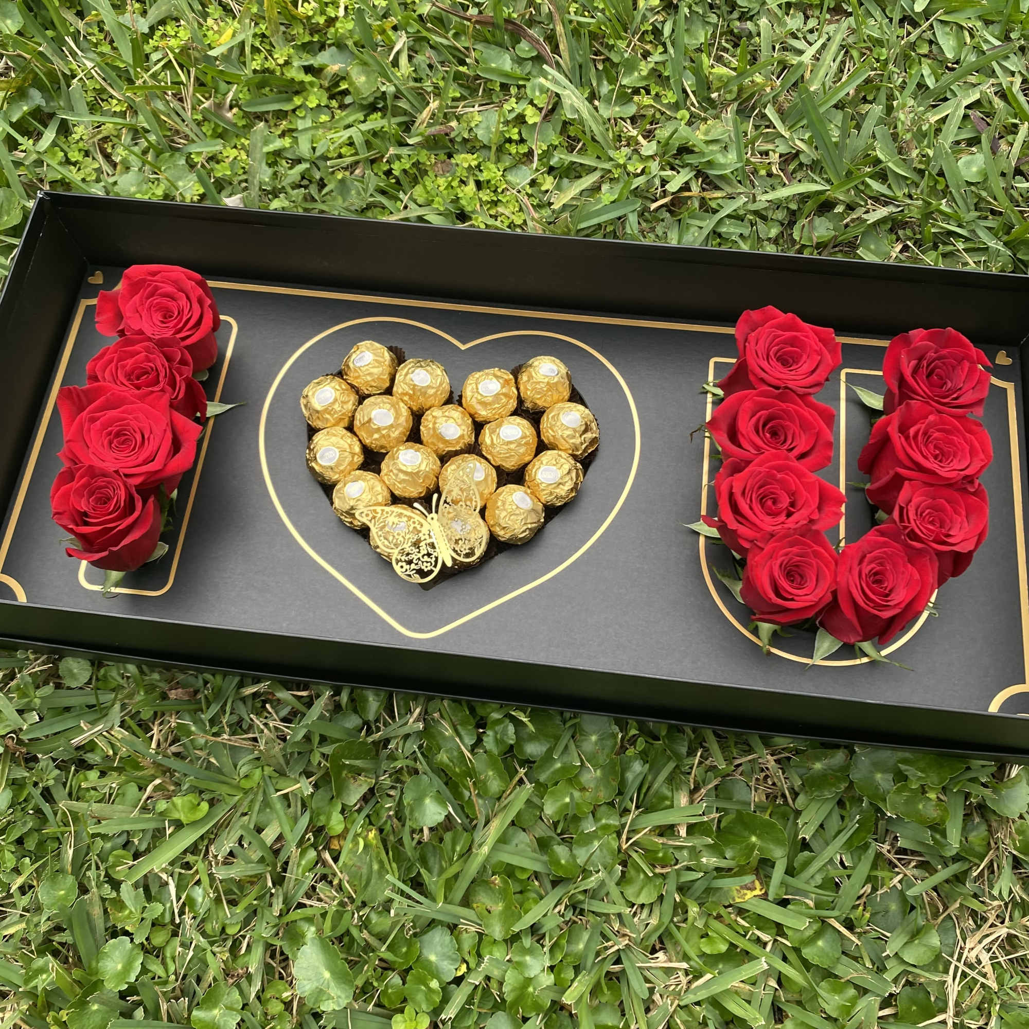 Box with roses and heart chocolate