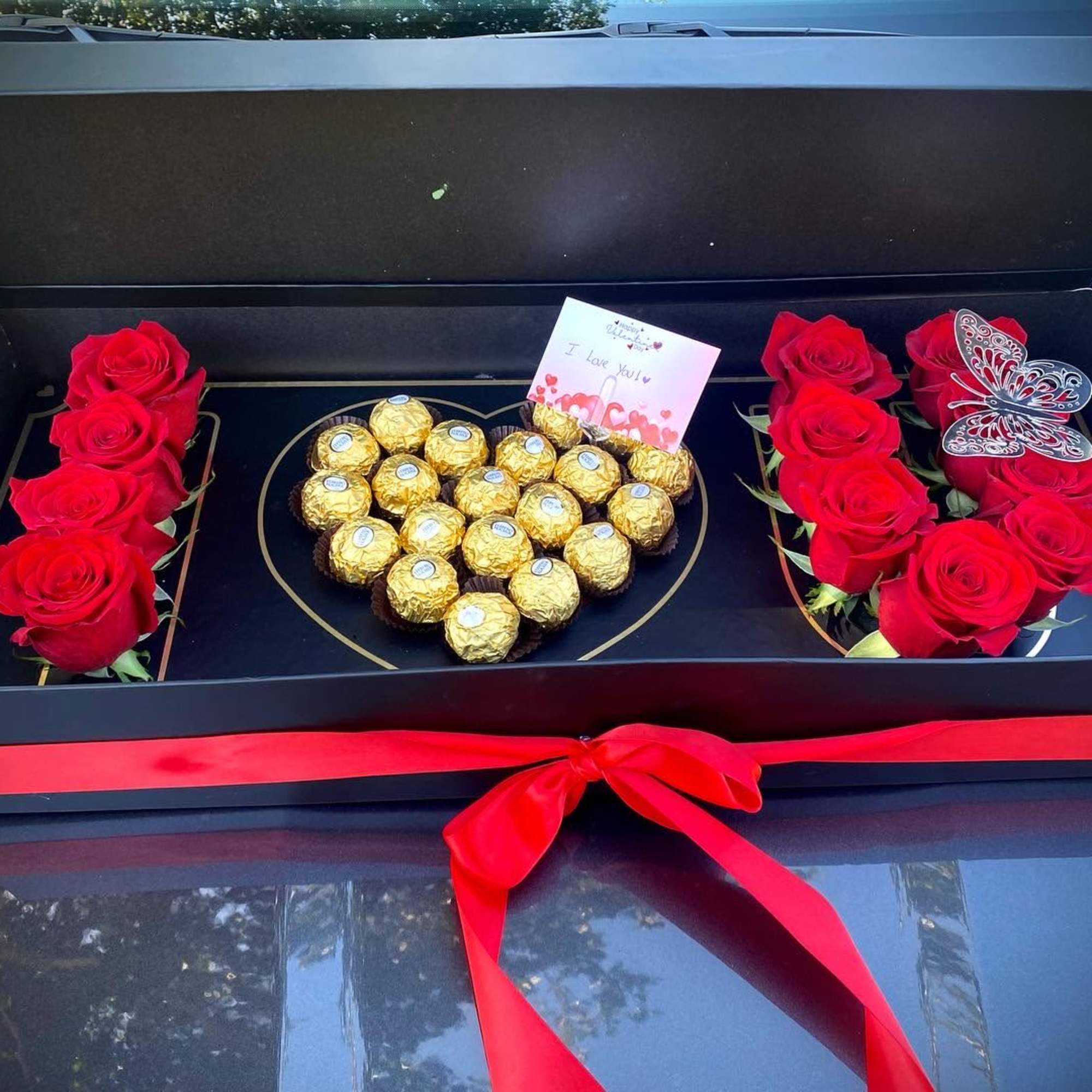 Box with roses and heart chocolate