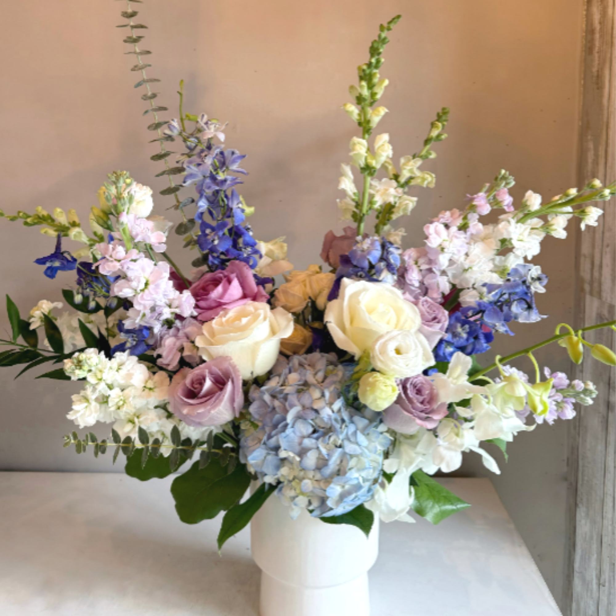 This asymmetric arrangement exudes timeless elegance with a refined palette of blue