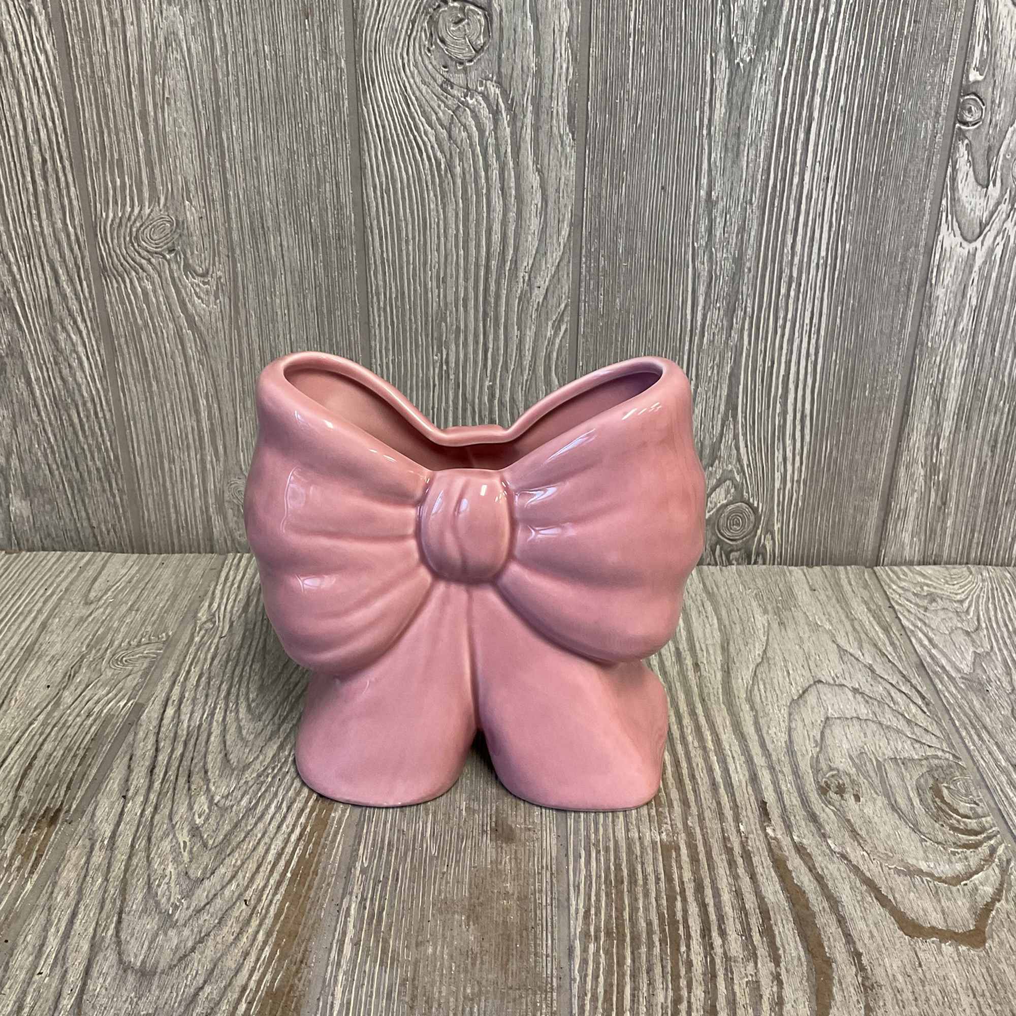 A lovely arrangement of fresh cut flowers arranged in a light pink