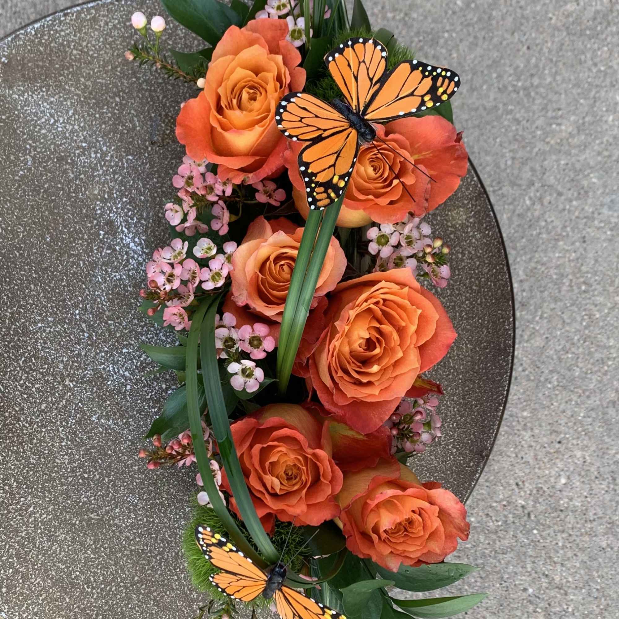 6 free spirit roses in a low black ceramic rectangle with beautiful