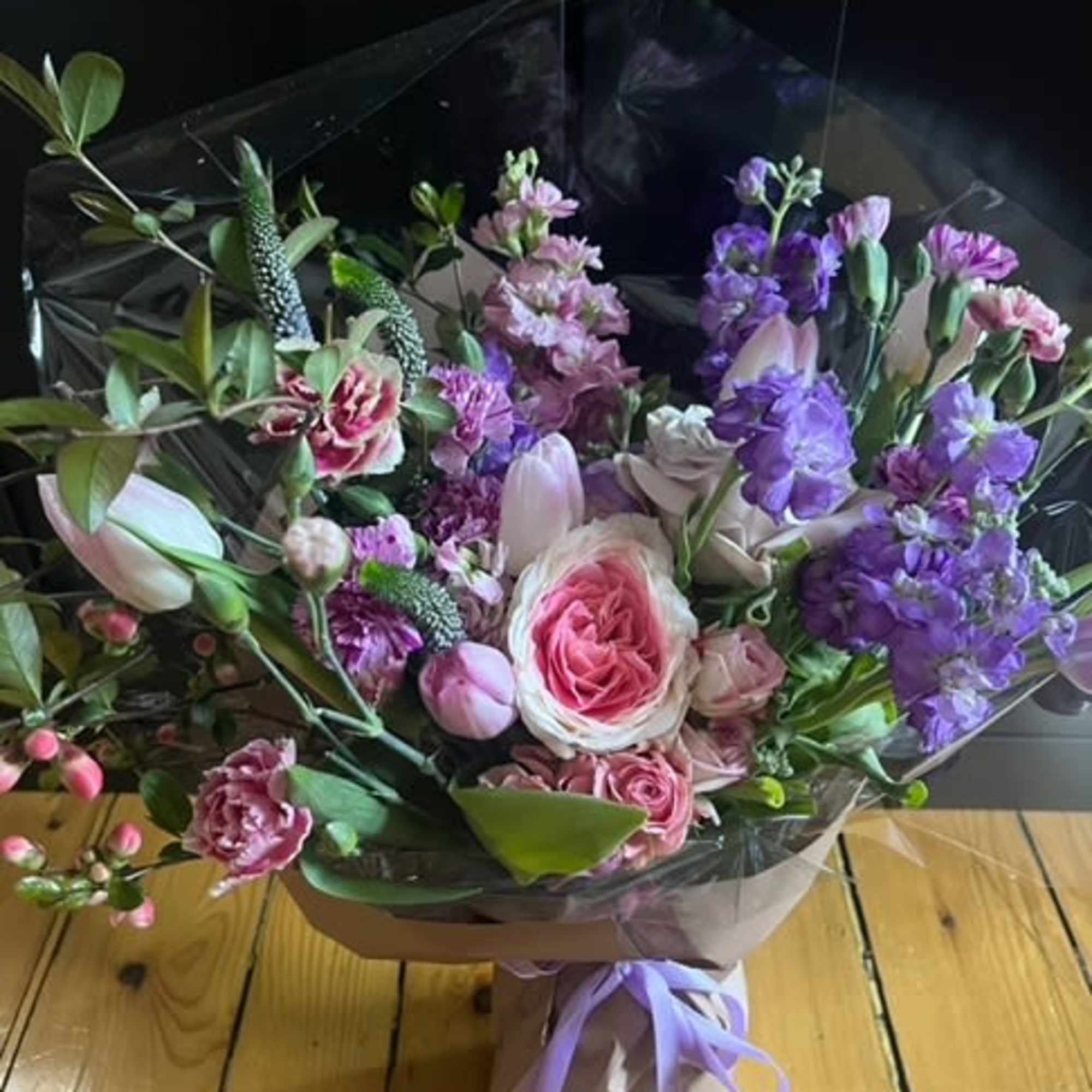 A beautiful pastel bundle of roses, spray roses, tulips, stock, mini carnations