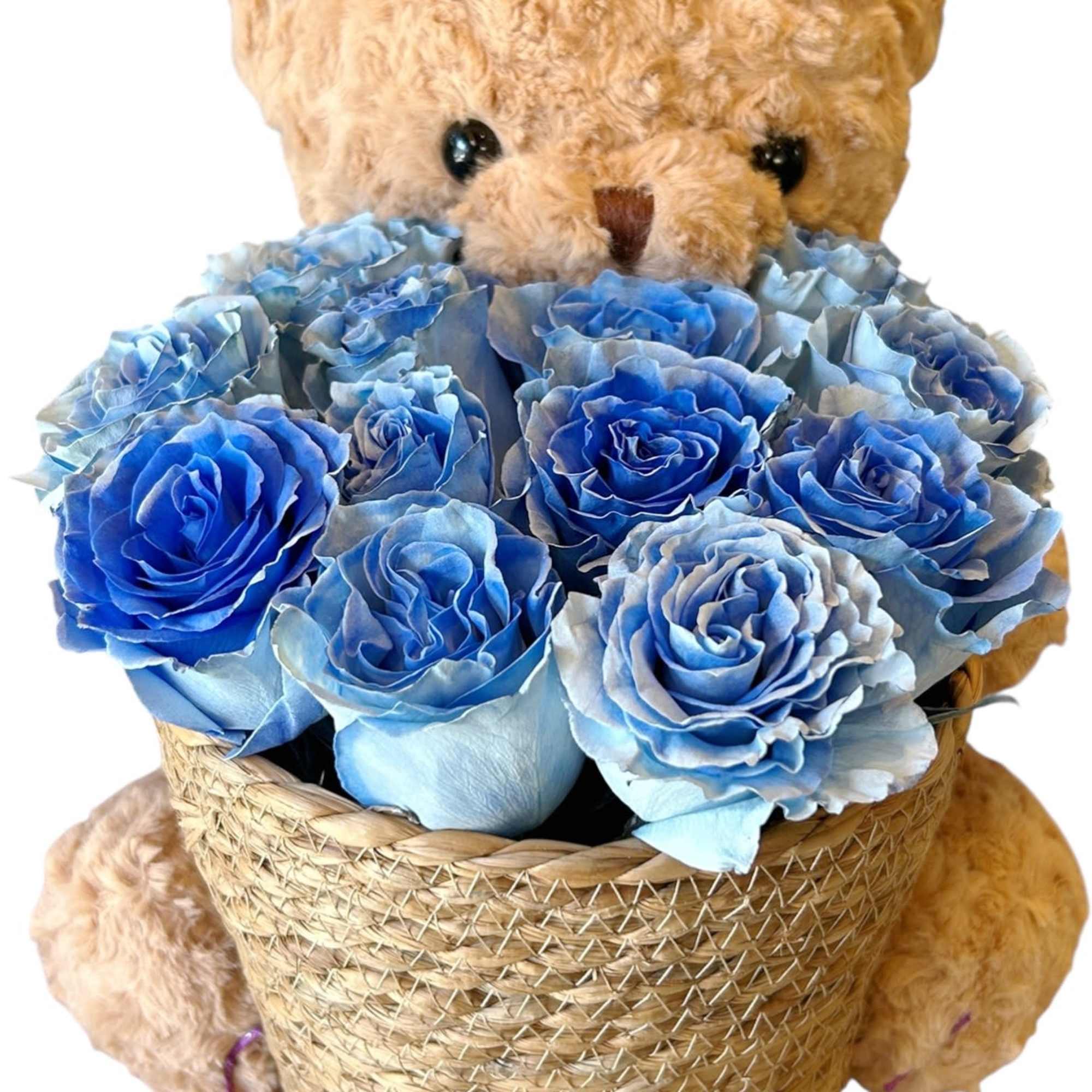 A sweet teddy bear cuddles a basket of delicate blue roses, as