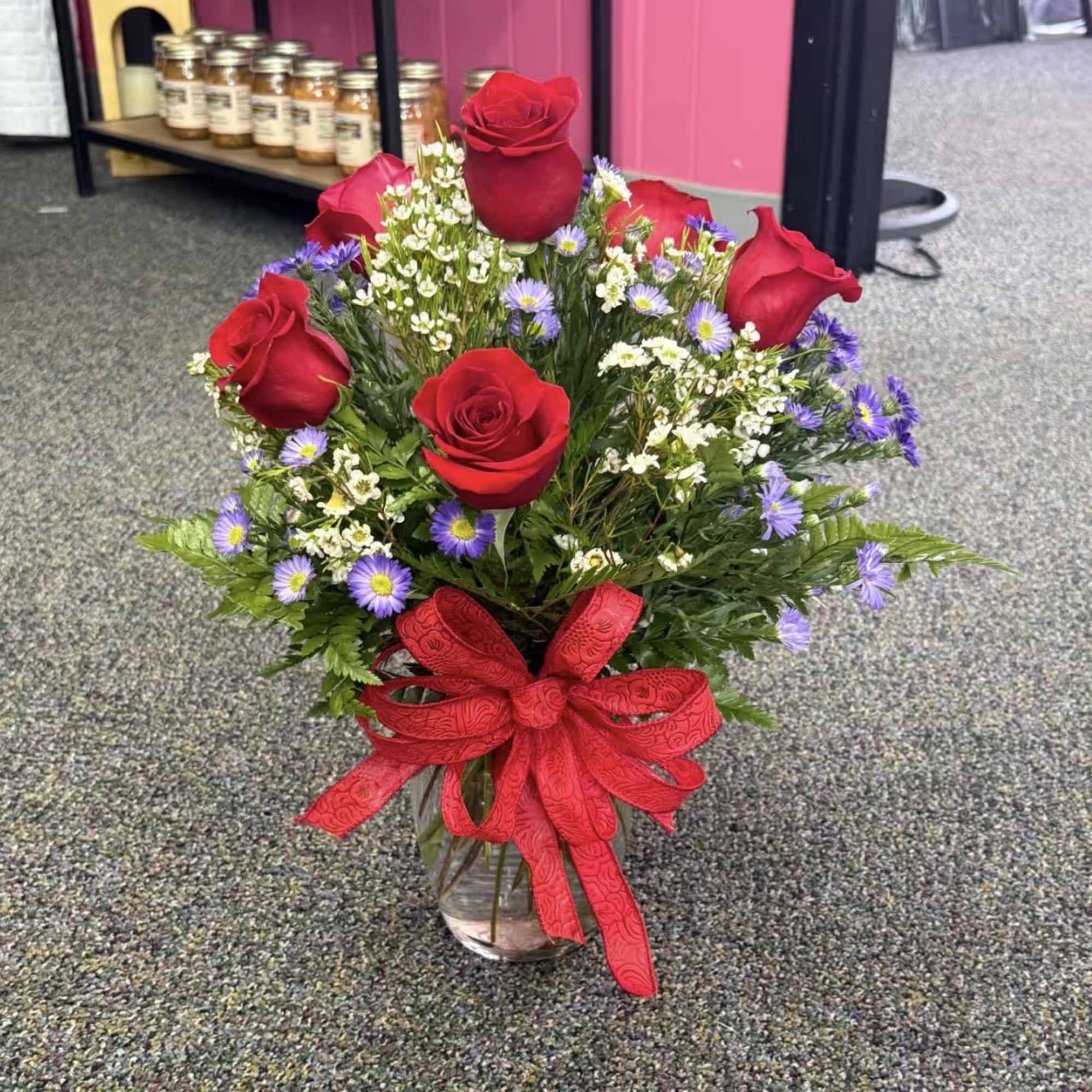 A stunning half dozen roses, hand-designed with care and wrapped or arranged