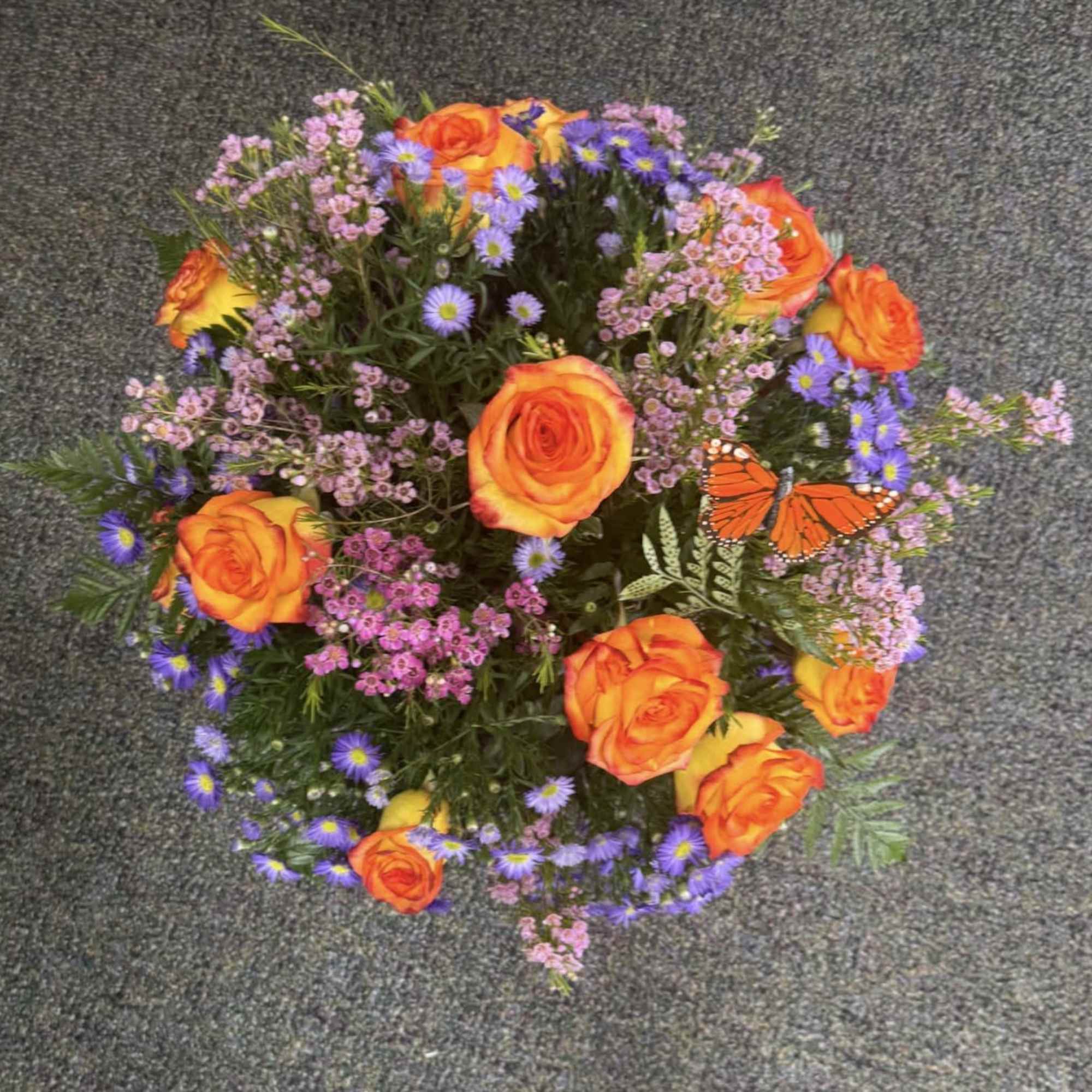 Twelve beautiful roses arranged with fresh greenery and Valentine accents. A timeless