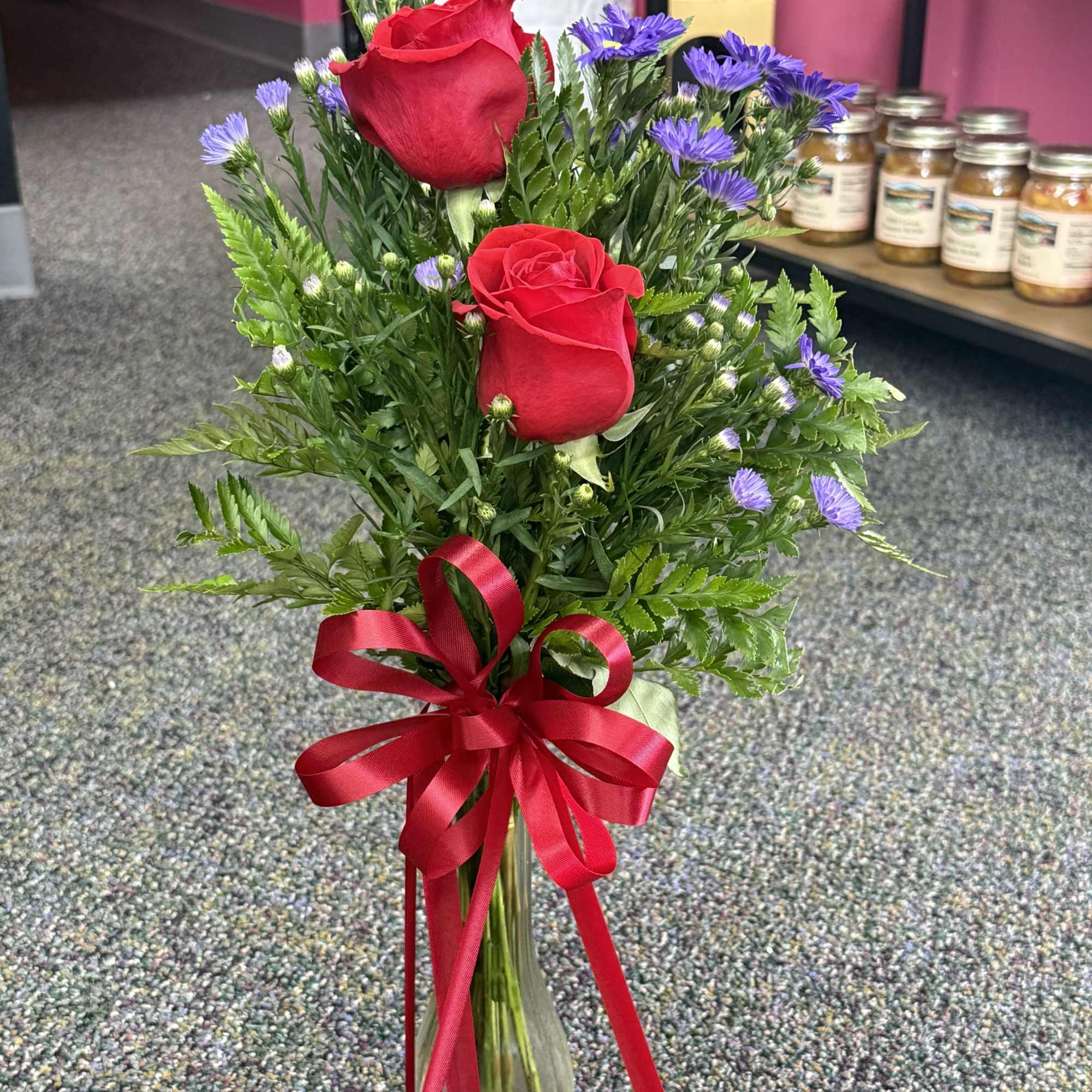 Two fresh Valentine blooms arranged side by side in a clear glass