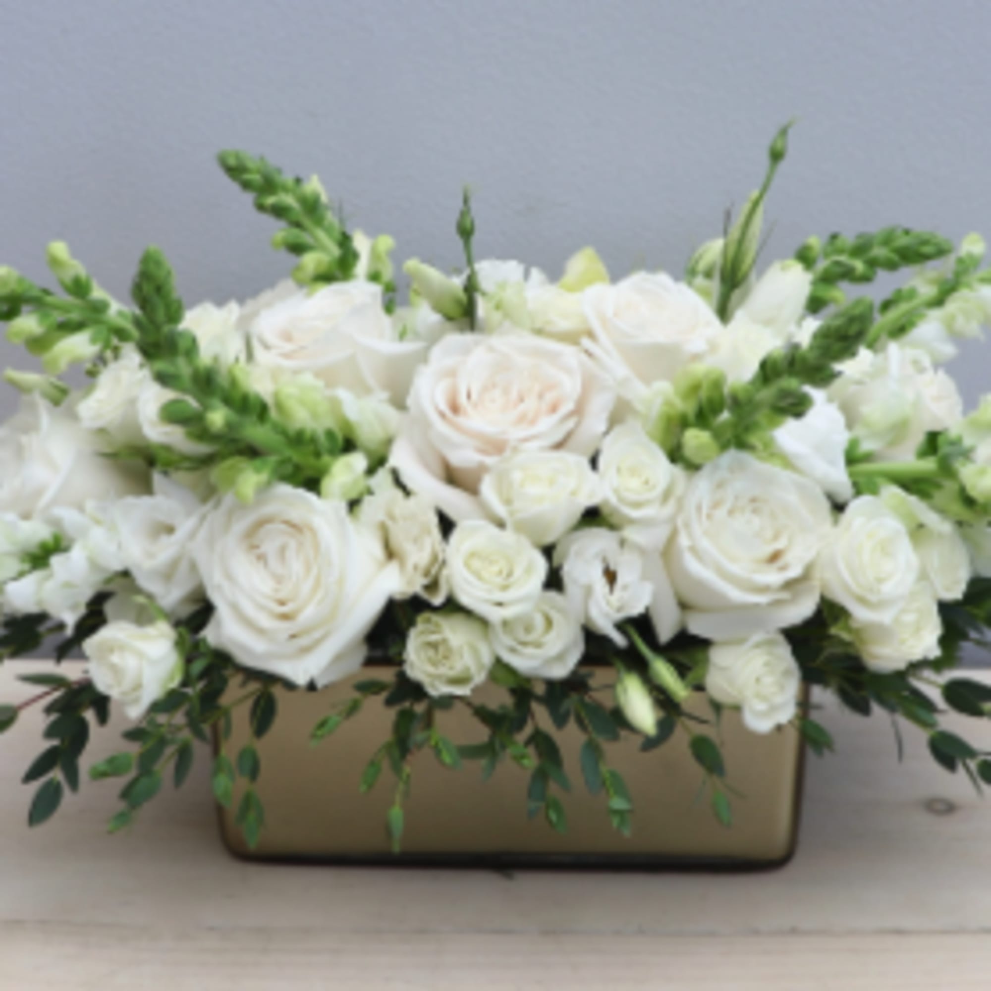 One of our newest creations. Roses, spray roses, and huck green arranged