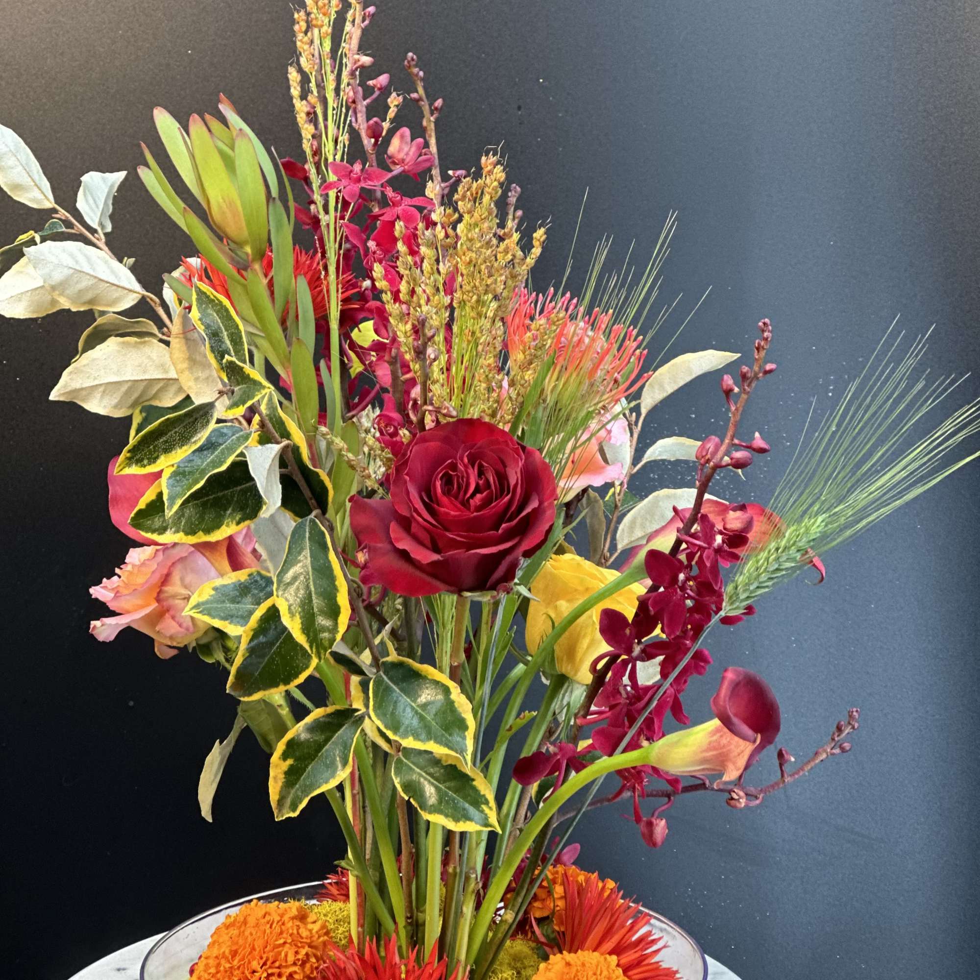 A refined Ikebana -style arrangement inspired by Japanese artistry .Sculptural blooms and