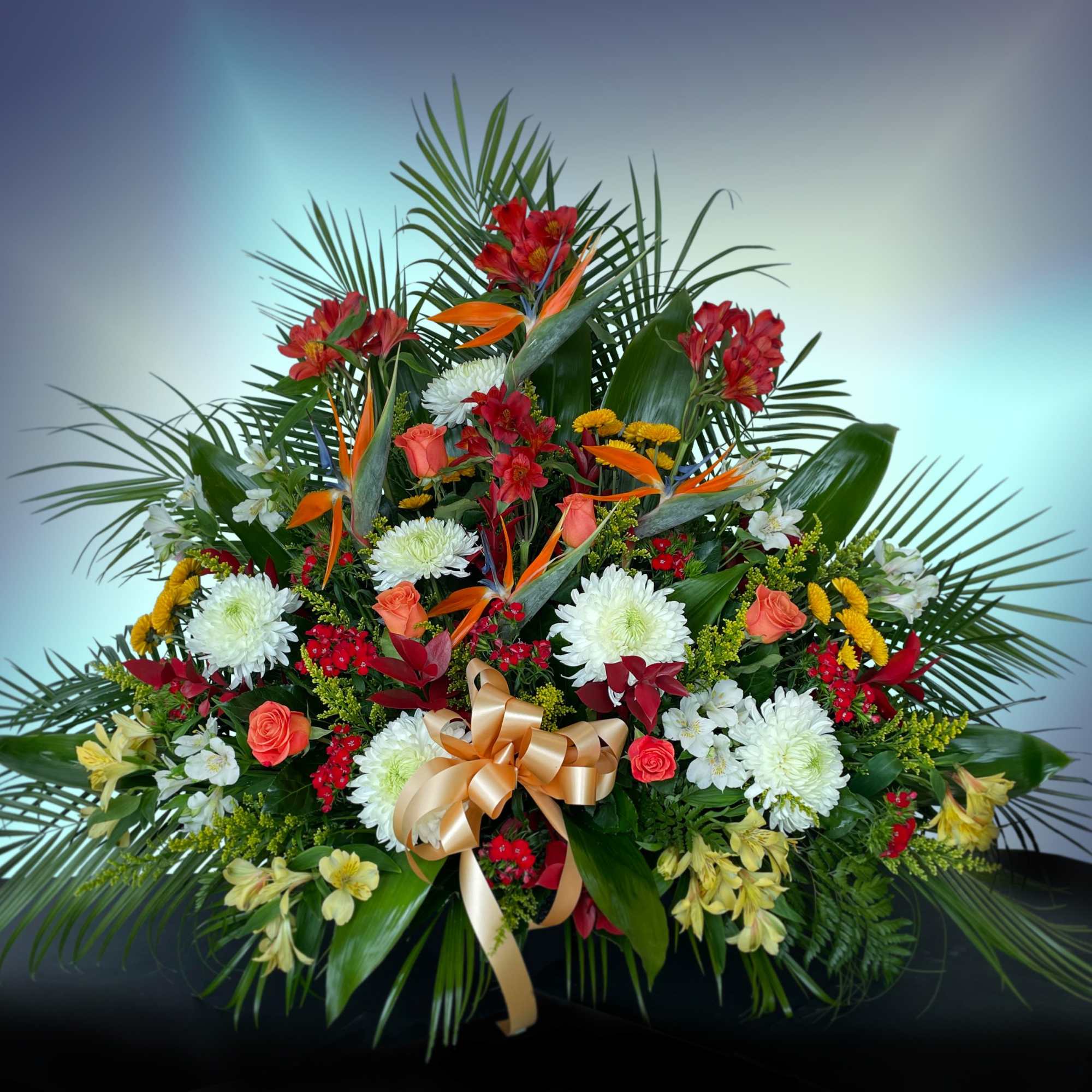 Birds of paradise, spray roses, chrysanthemums, and alstroemeria.