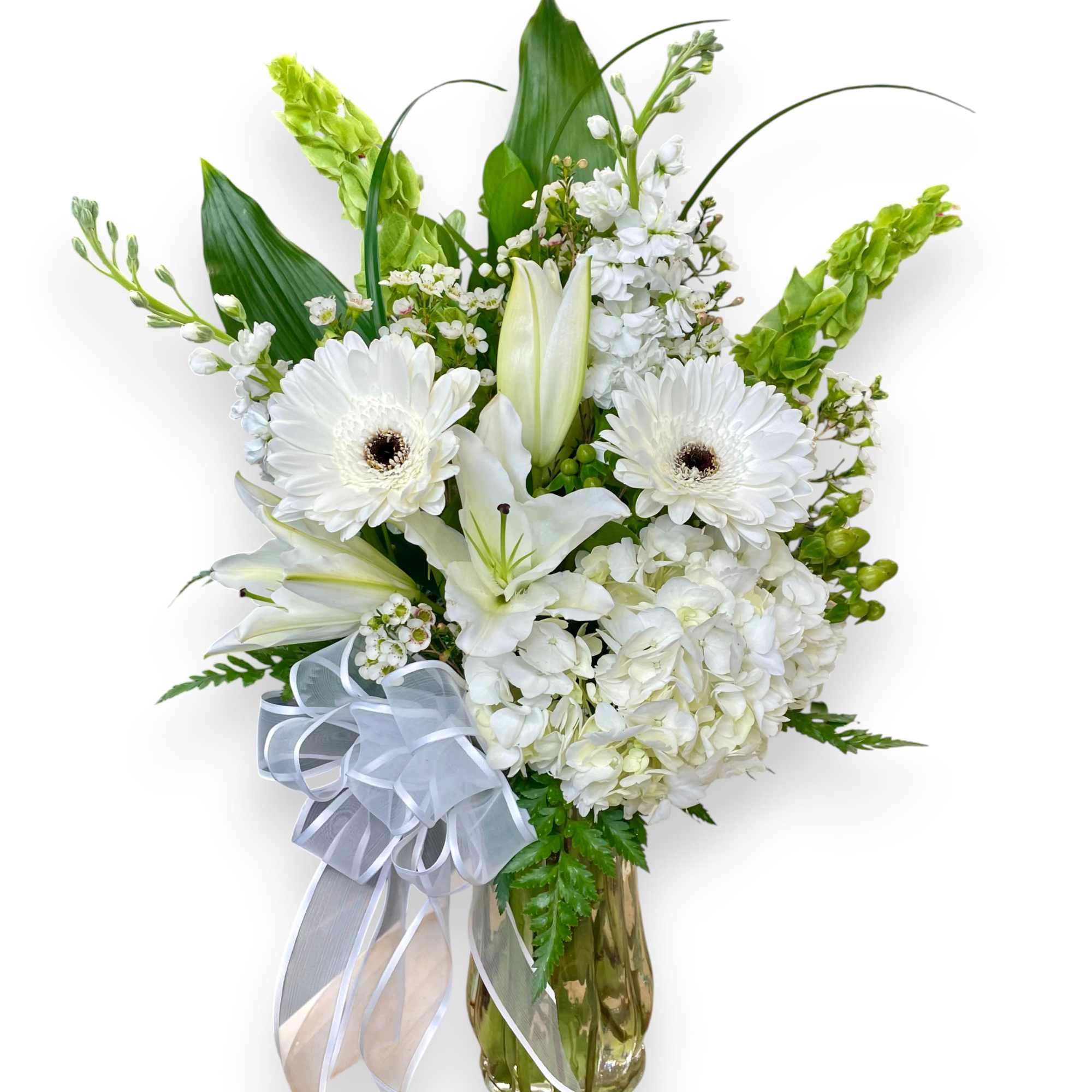 This beautiful arrangement features a selection of white flowers, including elegant lilies