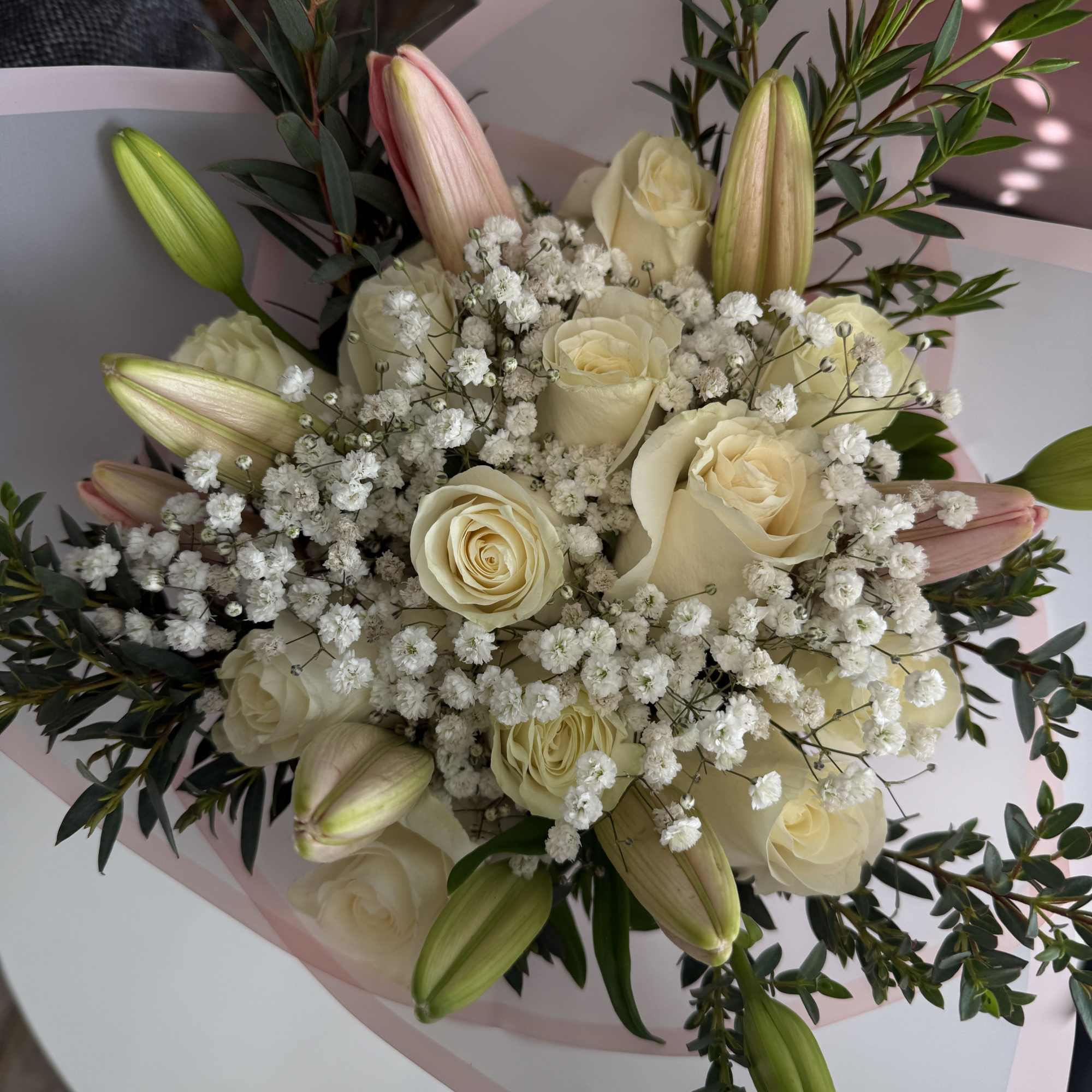 All round wrap with 12 White Roses &amp;  Pink Lilies

Please request