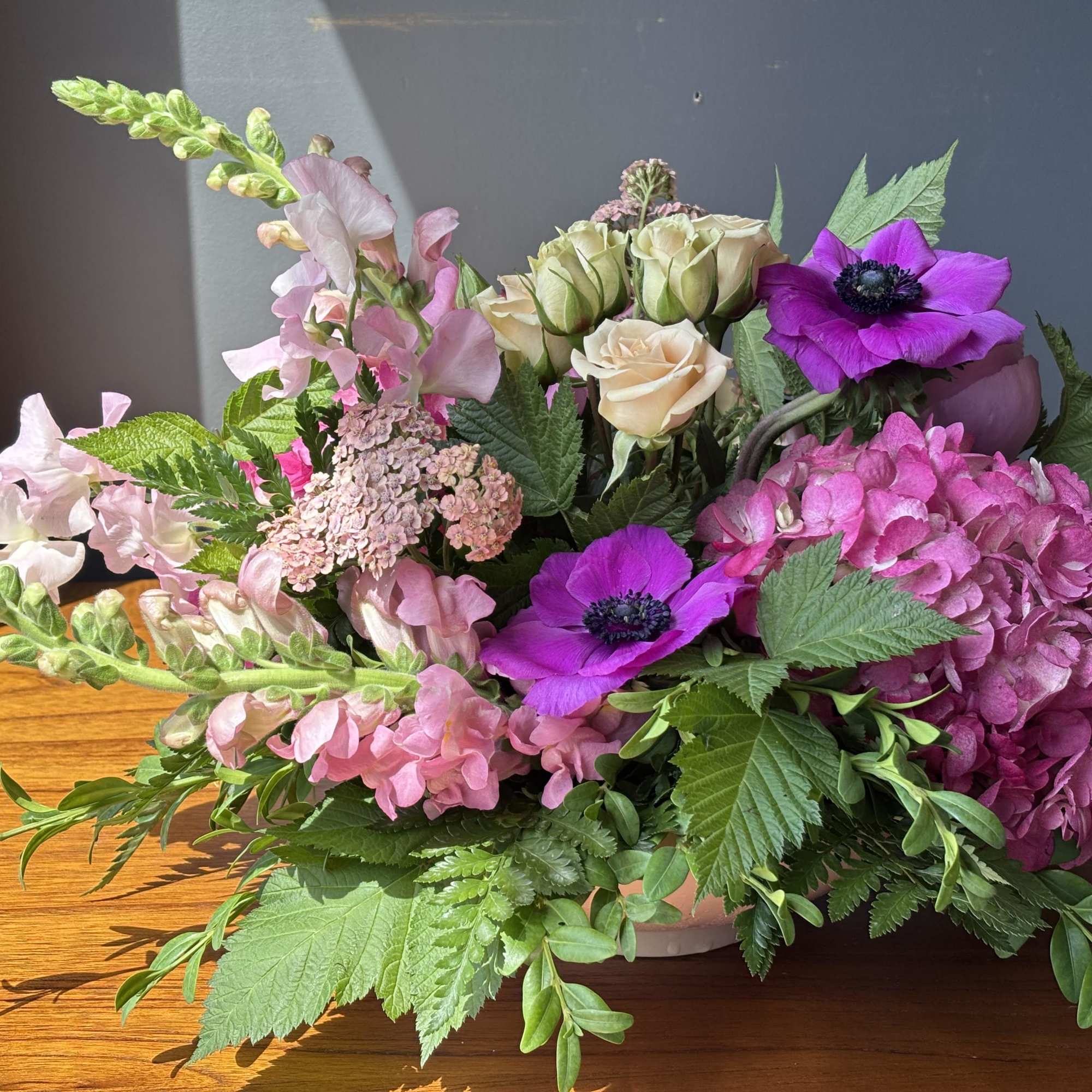 A low and lush, gardeny design in varying shades of pink. Arranged