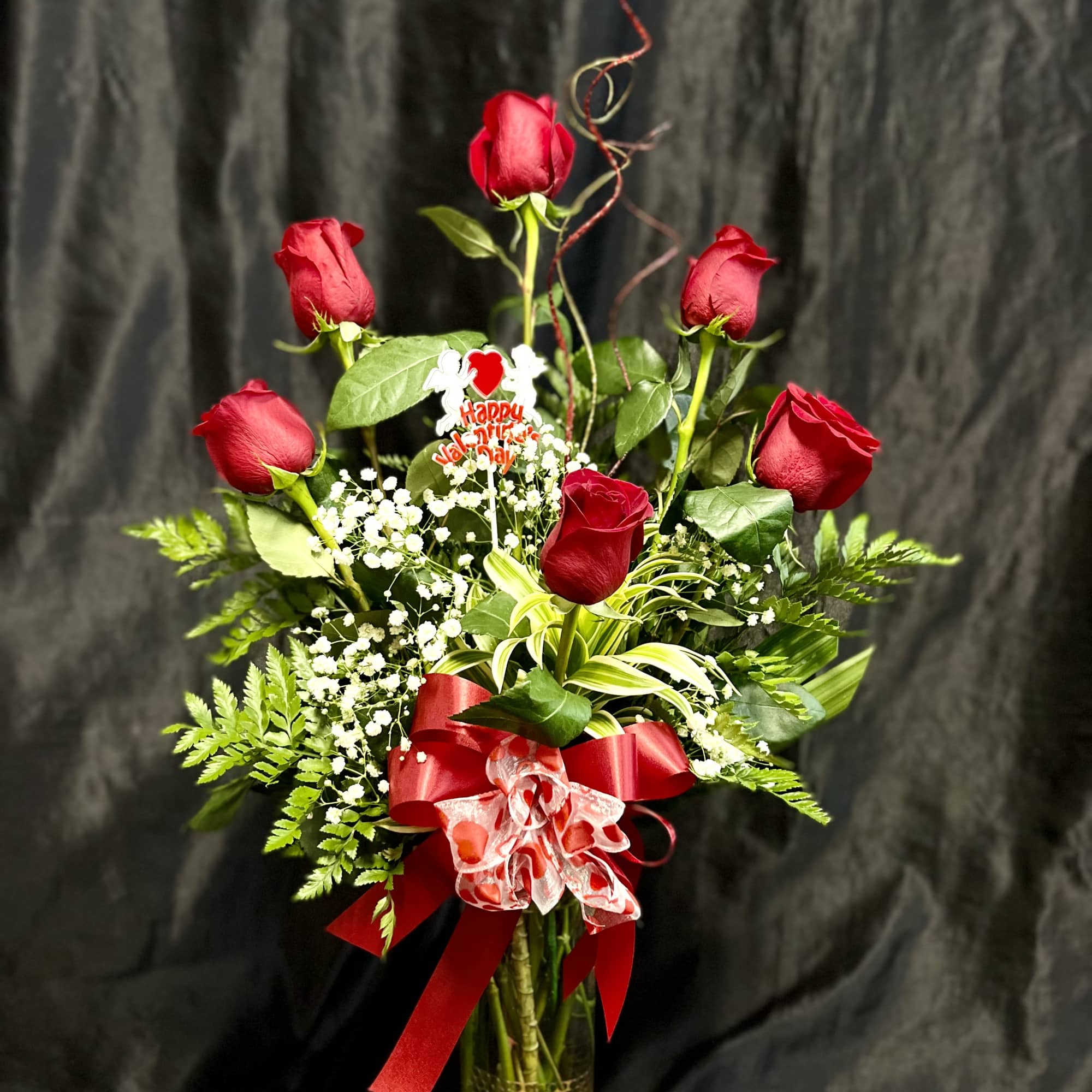 6 beautiful roses, leather leaf fern and babies breath to create this