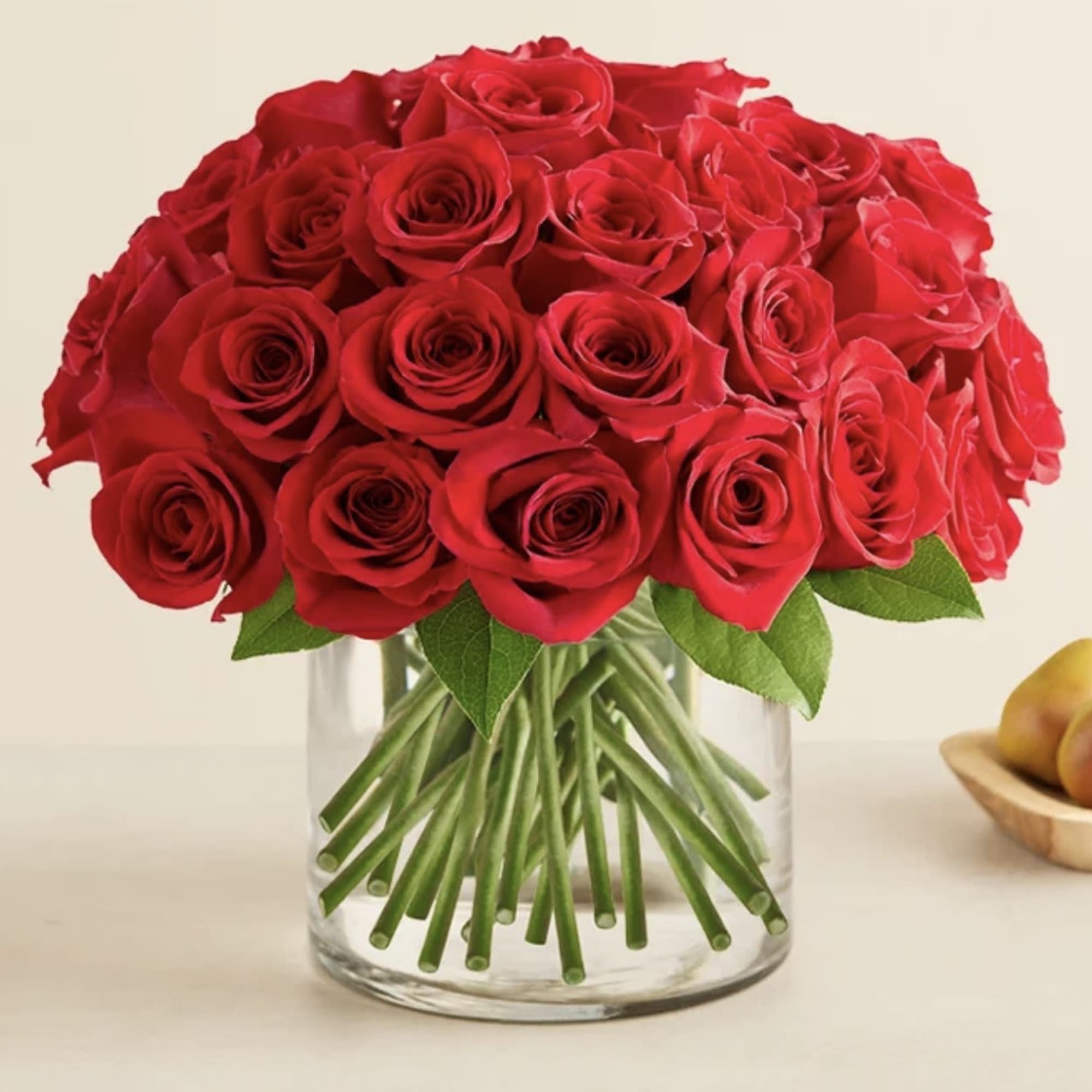 A stunning arrangement of premium red roses, beautifully styled in a clear