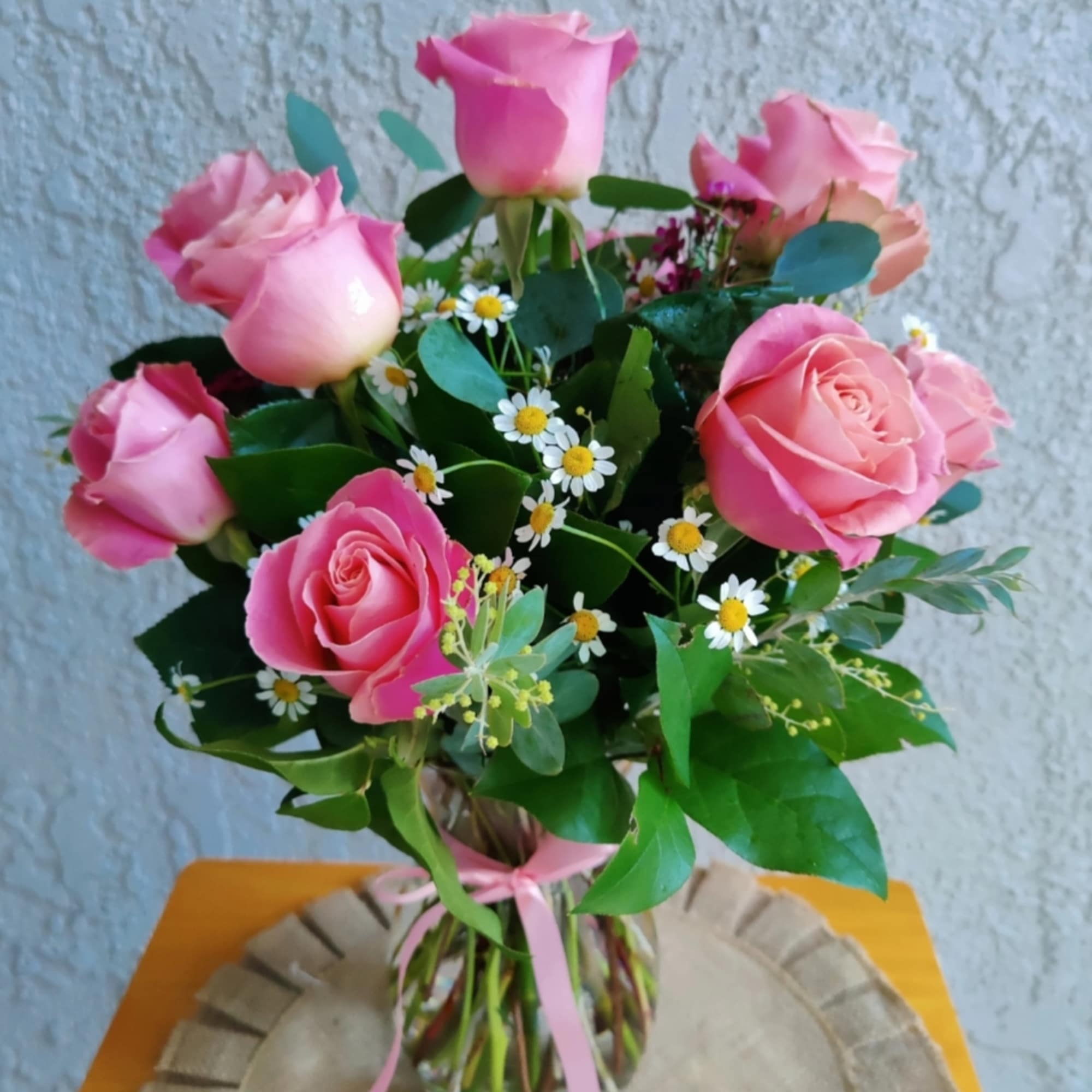 Beautiful floral arrangement decorated with 12 fresh quality roses in pink tones
