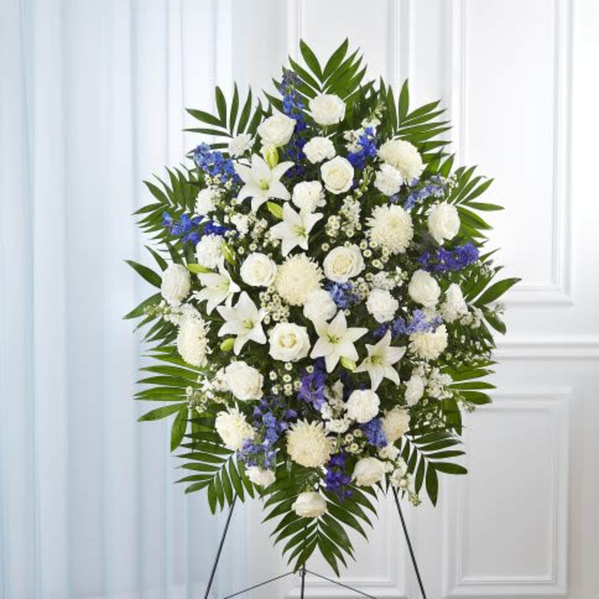 Standing spray arrangement with white roses, Asiatic lilies, football mums, carnations and