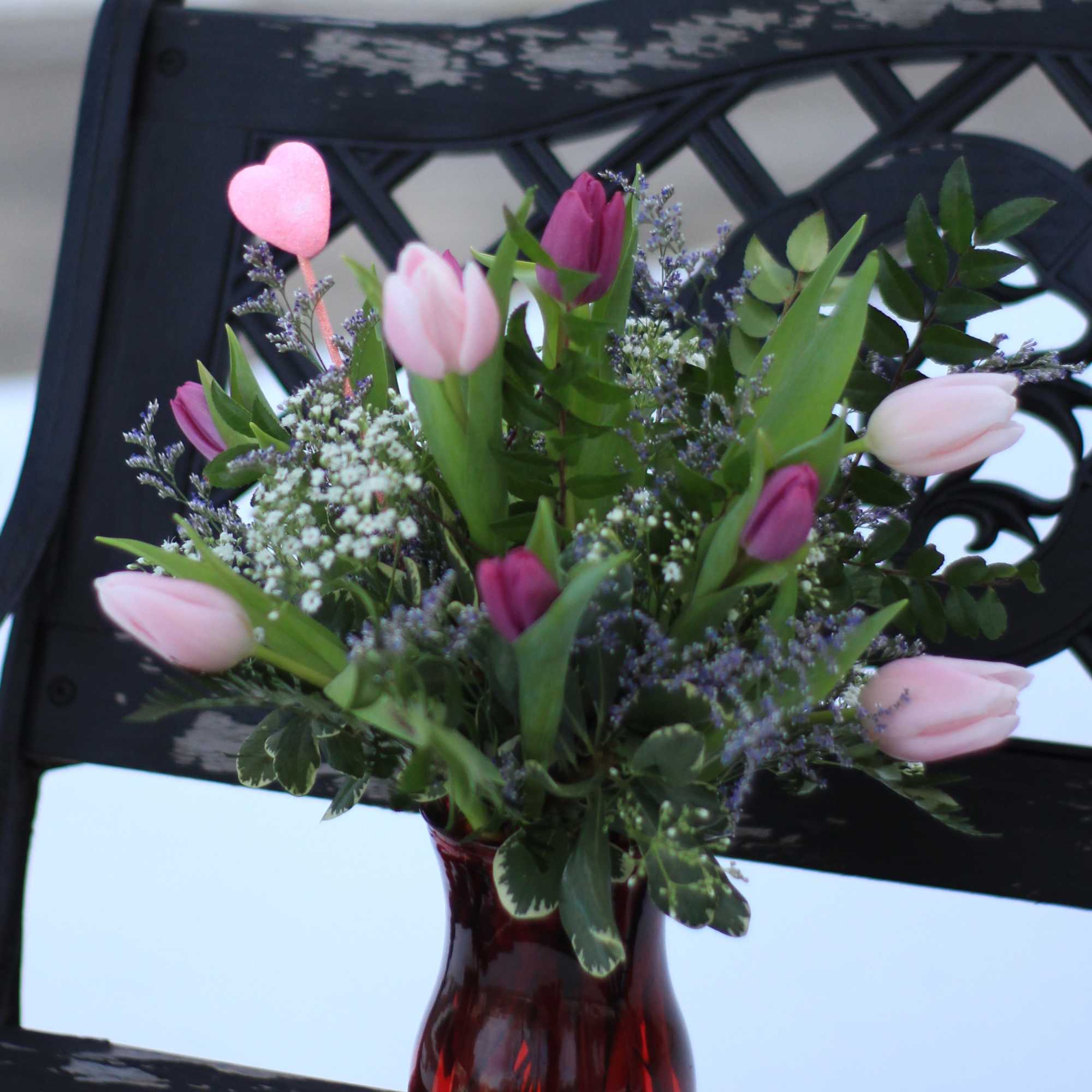 One bunch of beautiful fresh tulips arranged in a vase. These are
