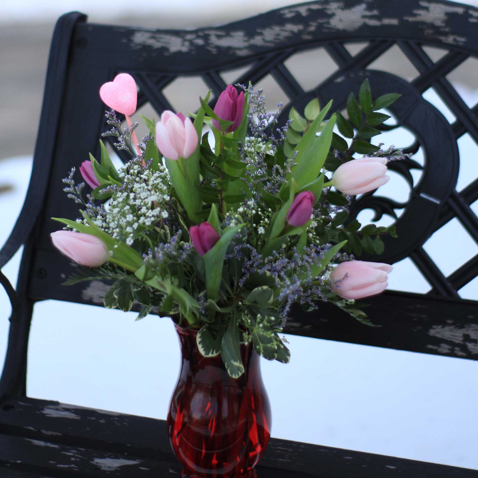 One bunch of beautiful fresh tulips arranged in a vase. These are