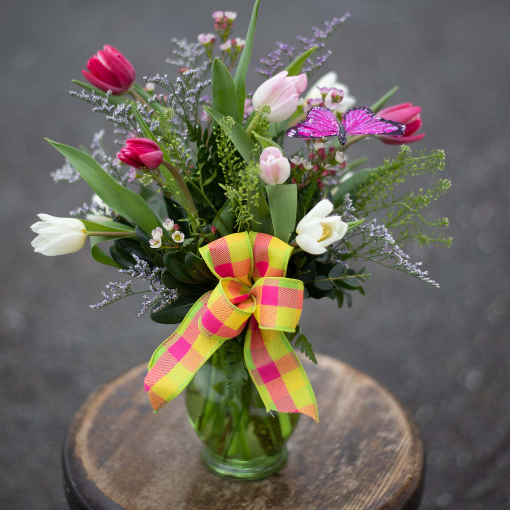 One bunch of beautiful fresh tulips arranged in a vase. These are