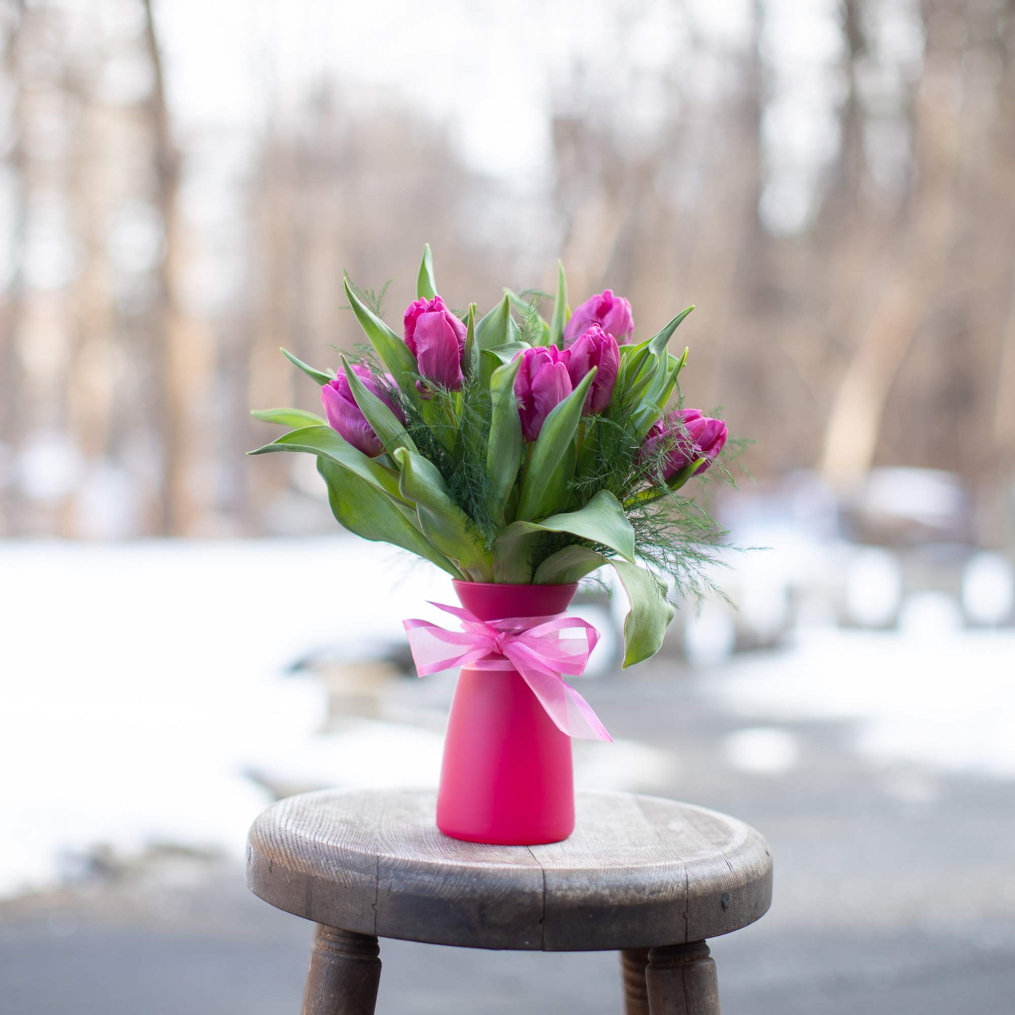 One bunch of beautiful fresh tulips arranged in a vase. These are