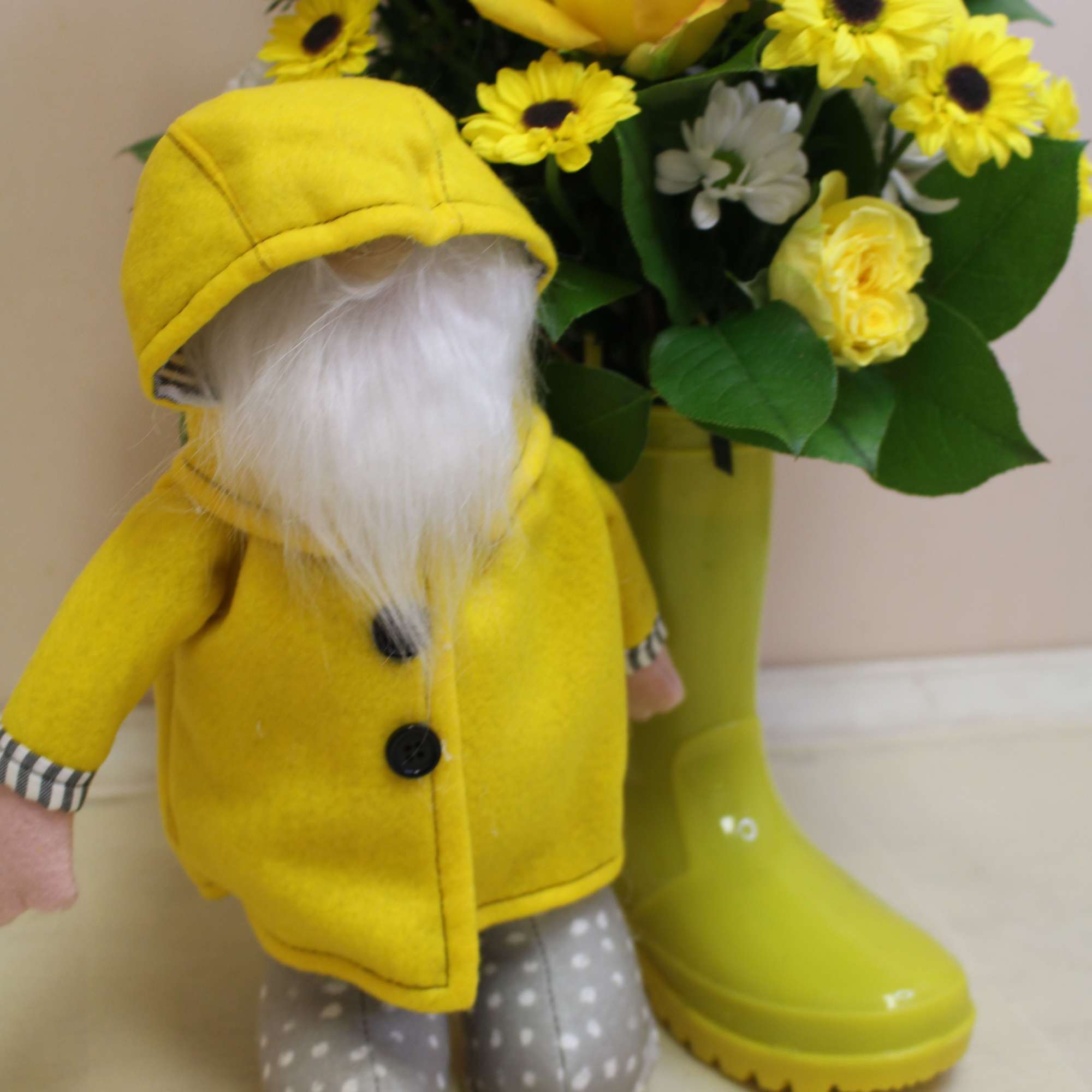 A cheerful spring arrangement with a cute gnome in a slicker, happily