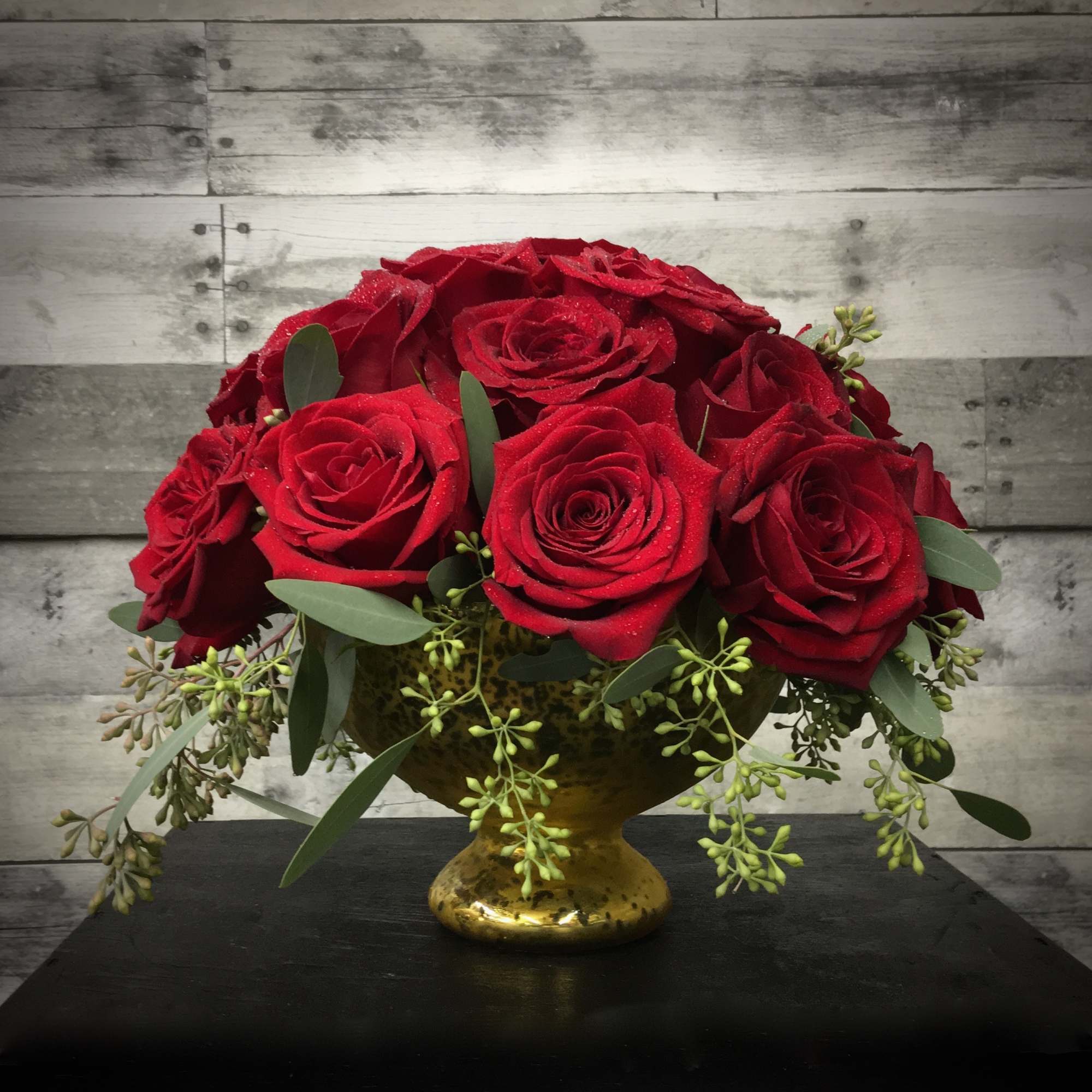 A lush cluster of  30 Red Roses in a Mercury Glass