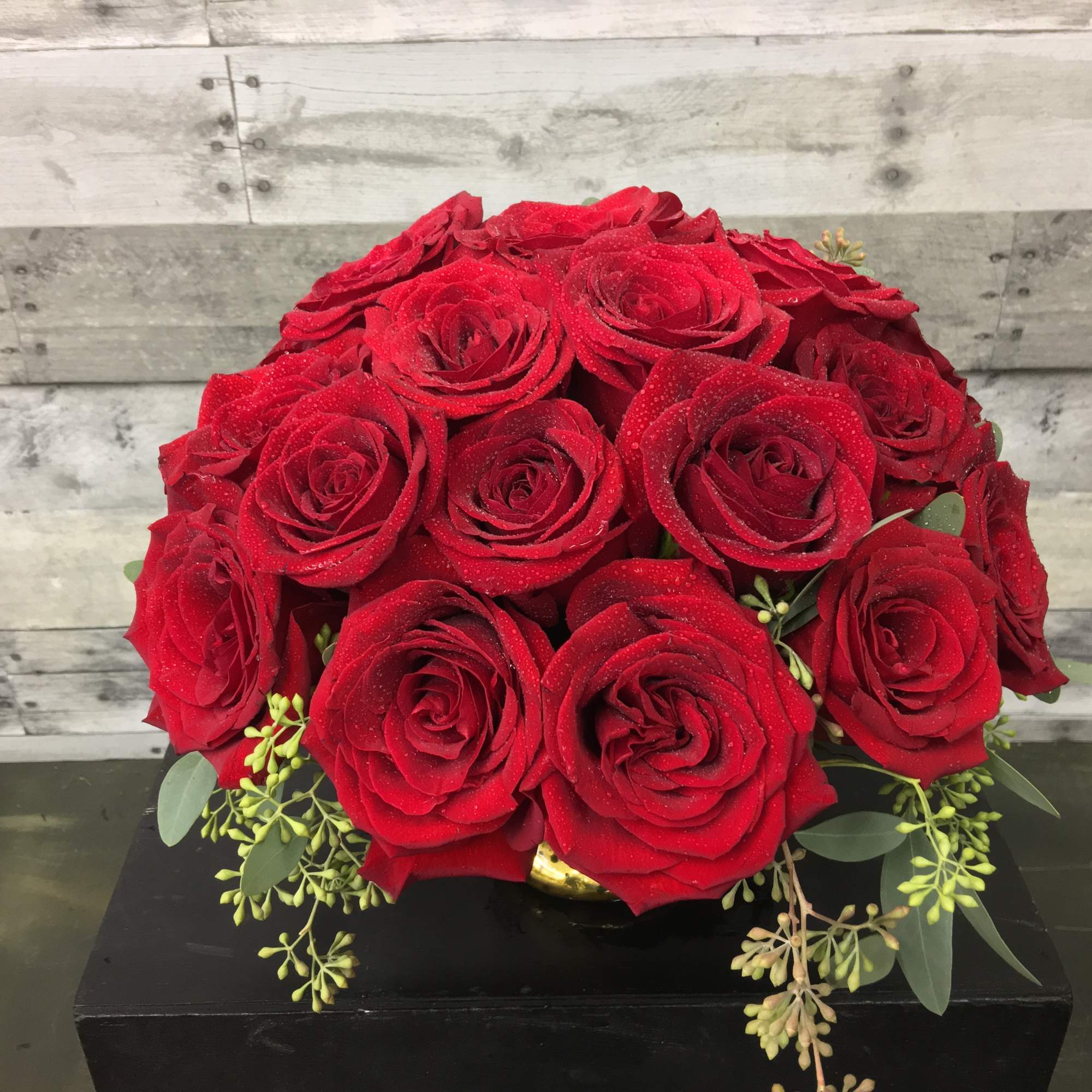 A lush cluster of  30 Red Roses in a Mercury Glass