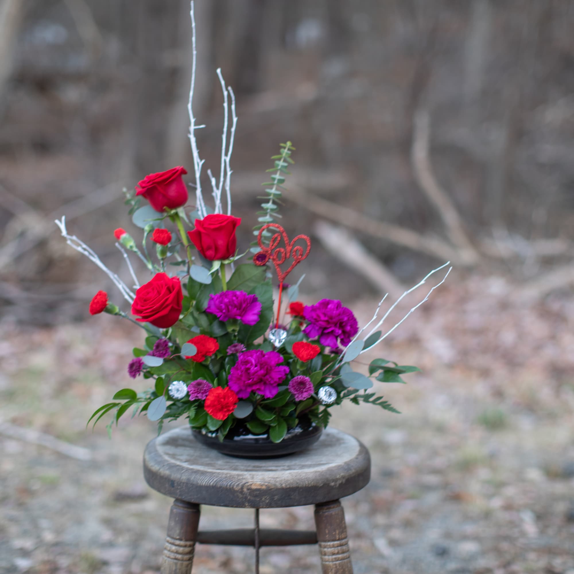 This arrangement is a contemporary design with a seasonal spirit to celebrate
