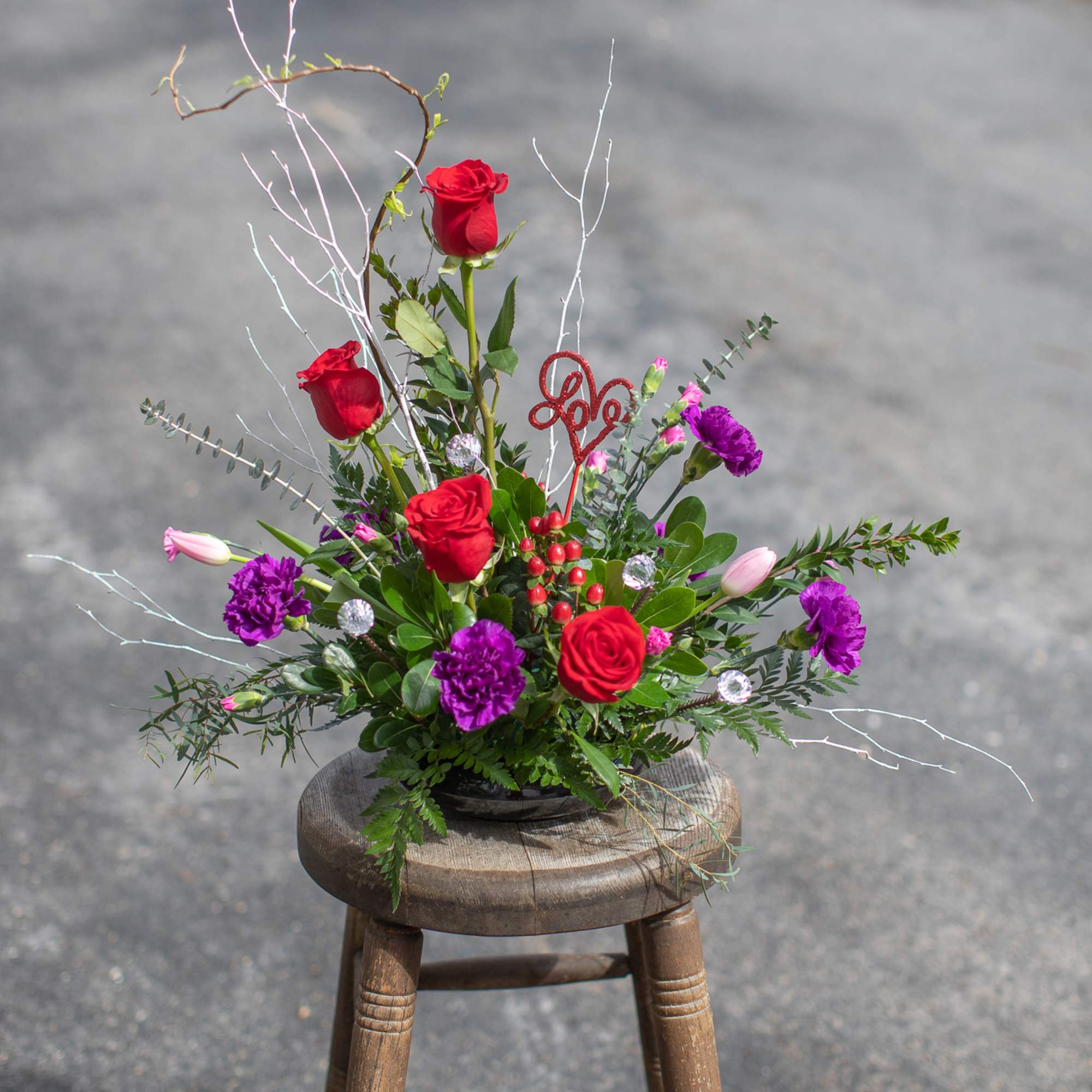 This arrangement is a contemporary design with a seasonal spirit to celebrate