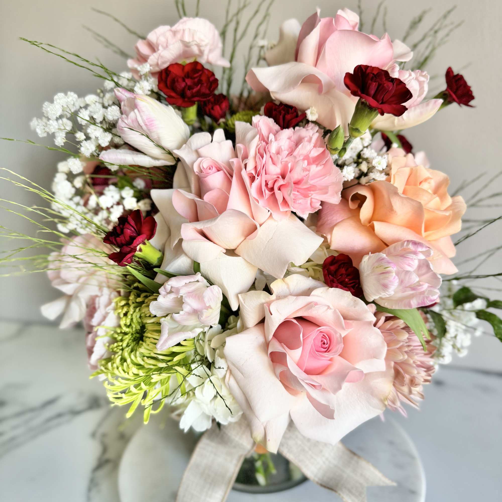 A one-of-a-kind arrangement designed with the freshest seasonal blooms, thoughtfully crafted to