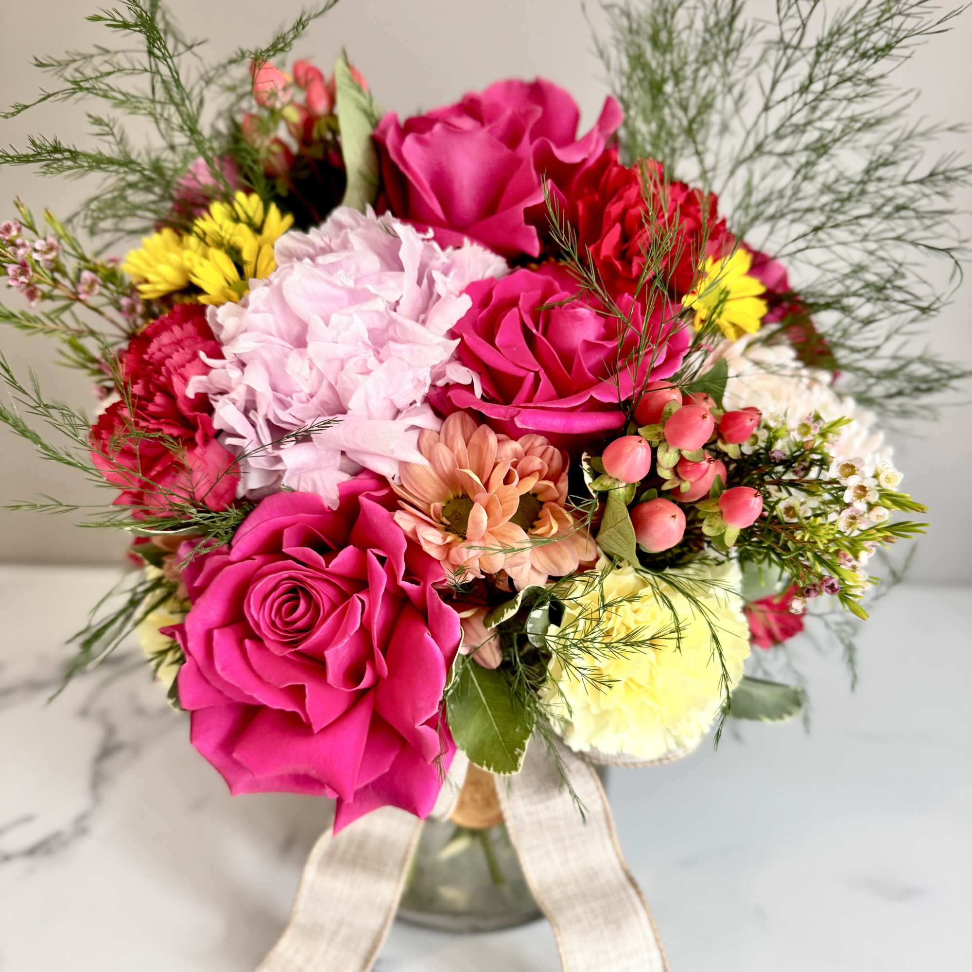 A one-of-a-kind arrangement designed with the freshest seasonal blooms, thoughtfully crafted to