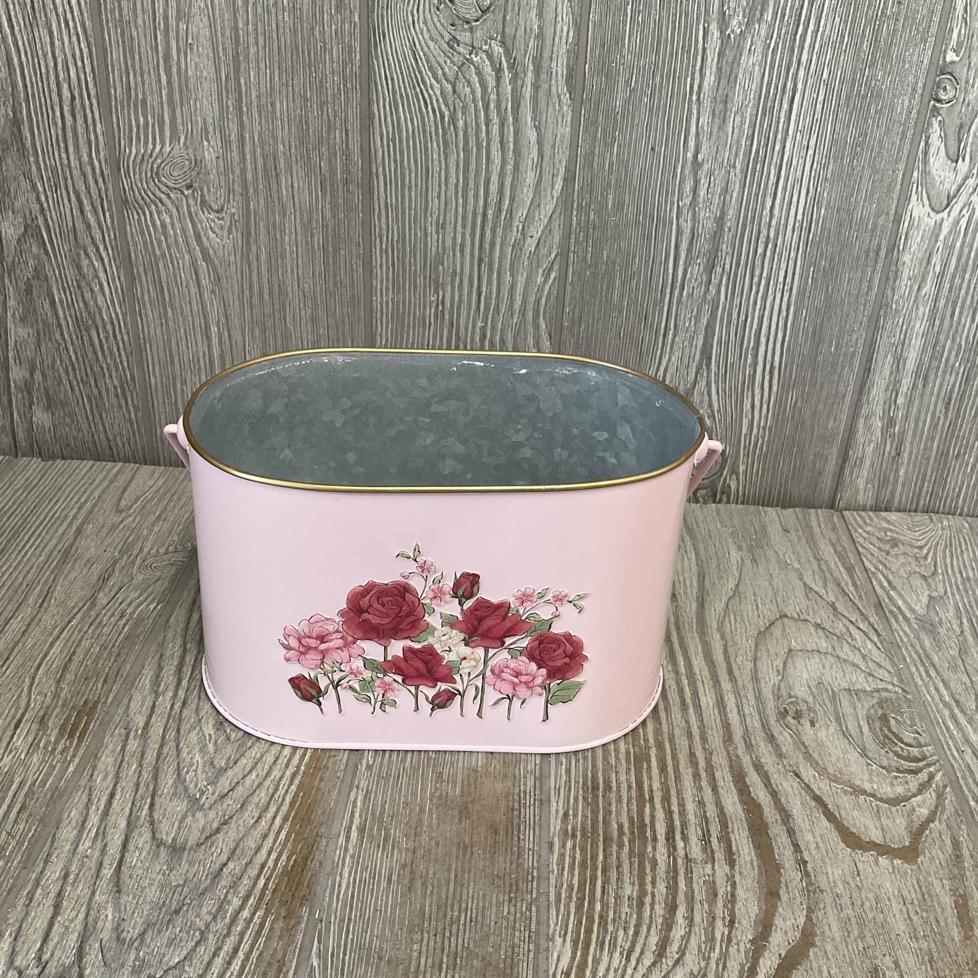 A beautiful bouquet of mixed flowers arranged in a keepsake metal planter