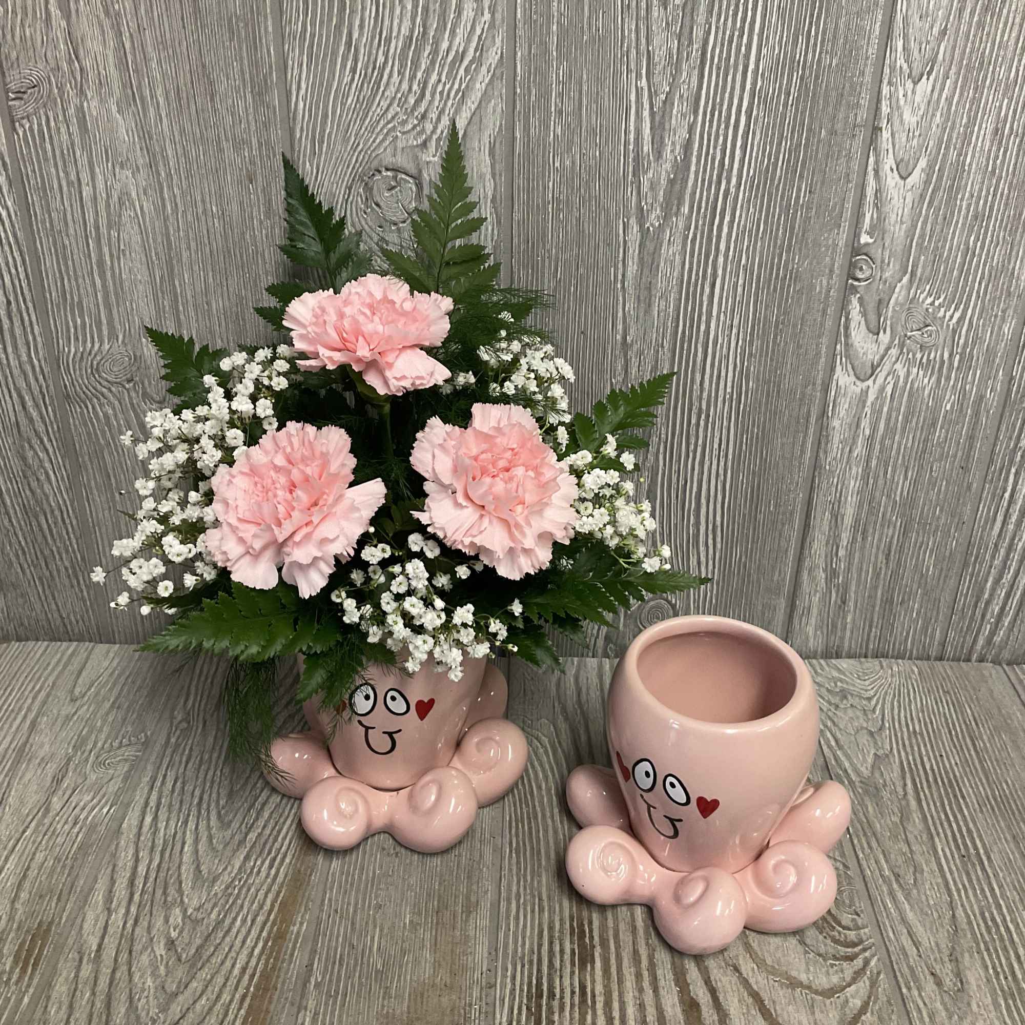 Fresh cut flowers arranged in a keepsake ceramic Valentine&rsquo;s octopus container. Flowers