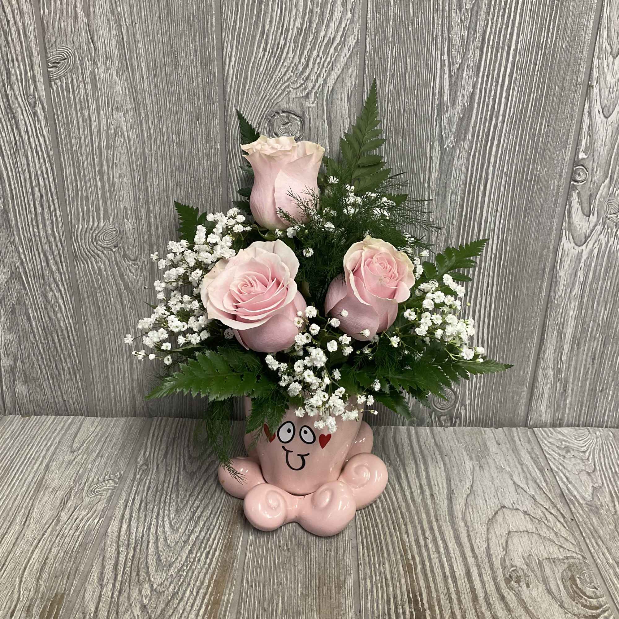 Fresh cut flowers arranged in a keepsake ceramic Valentine&rsquo;s octopus container. Flowers