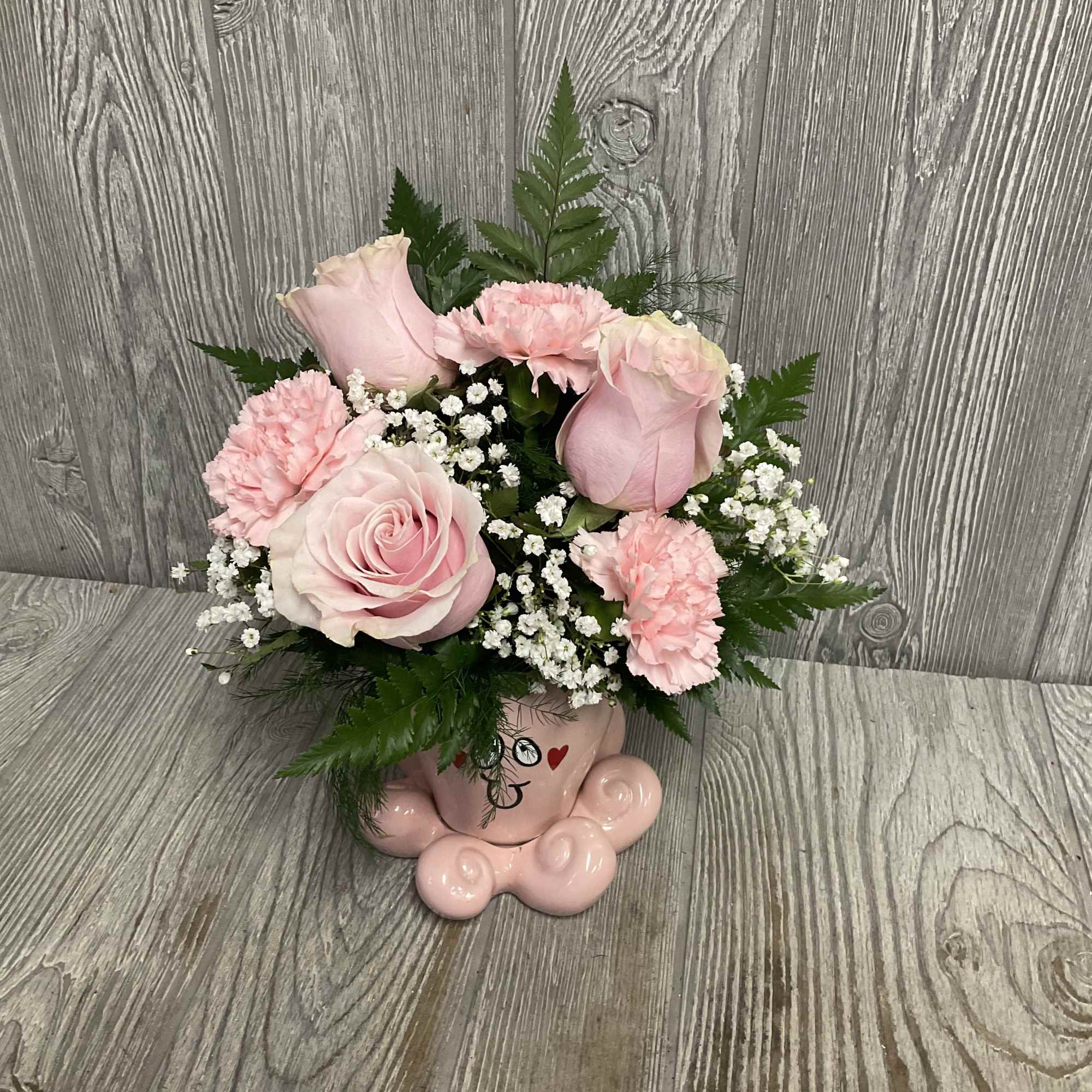 Fresh cut flowers arranged in a keepsake ceramic Valentine&rsquo;s octopus container. Flowers