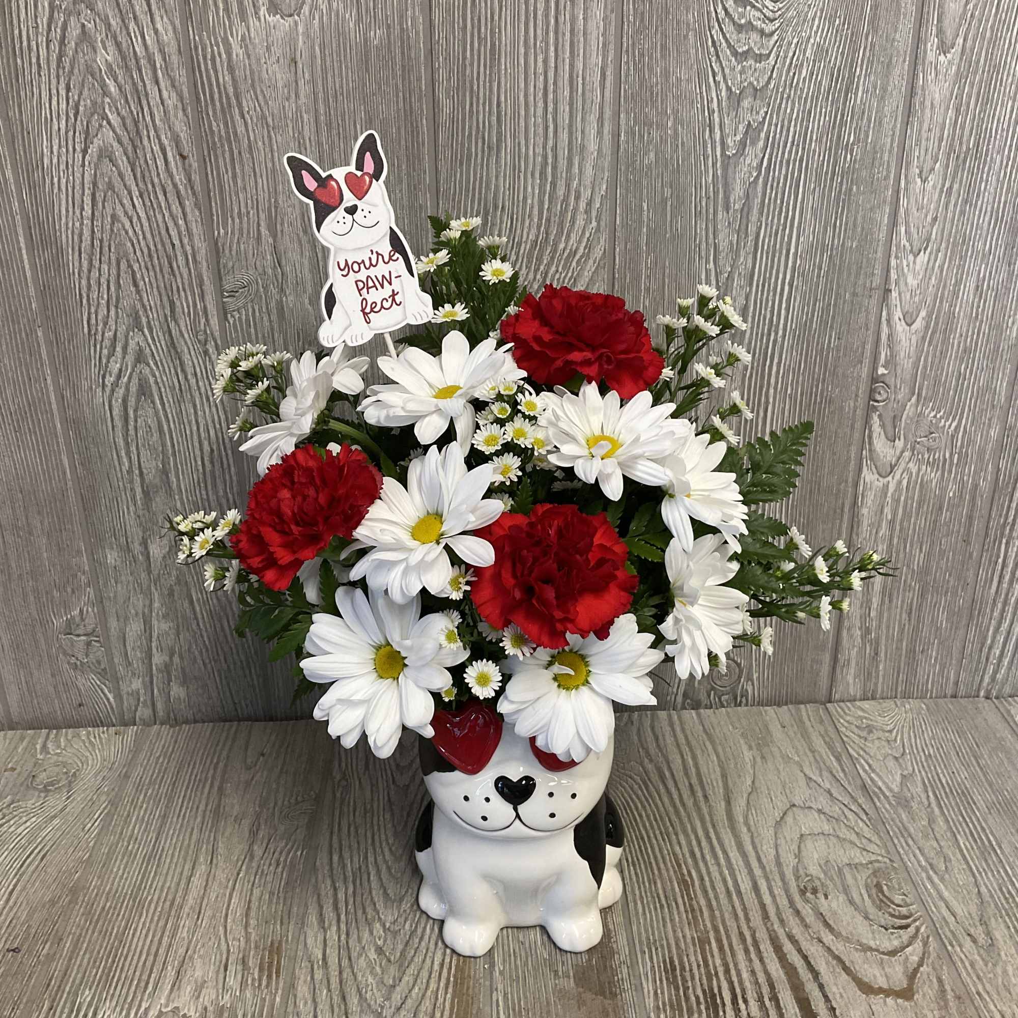 Beautiful fresh cut flowers arranged in a keepsake ceramic dog container. Flowers