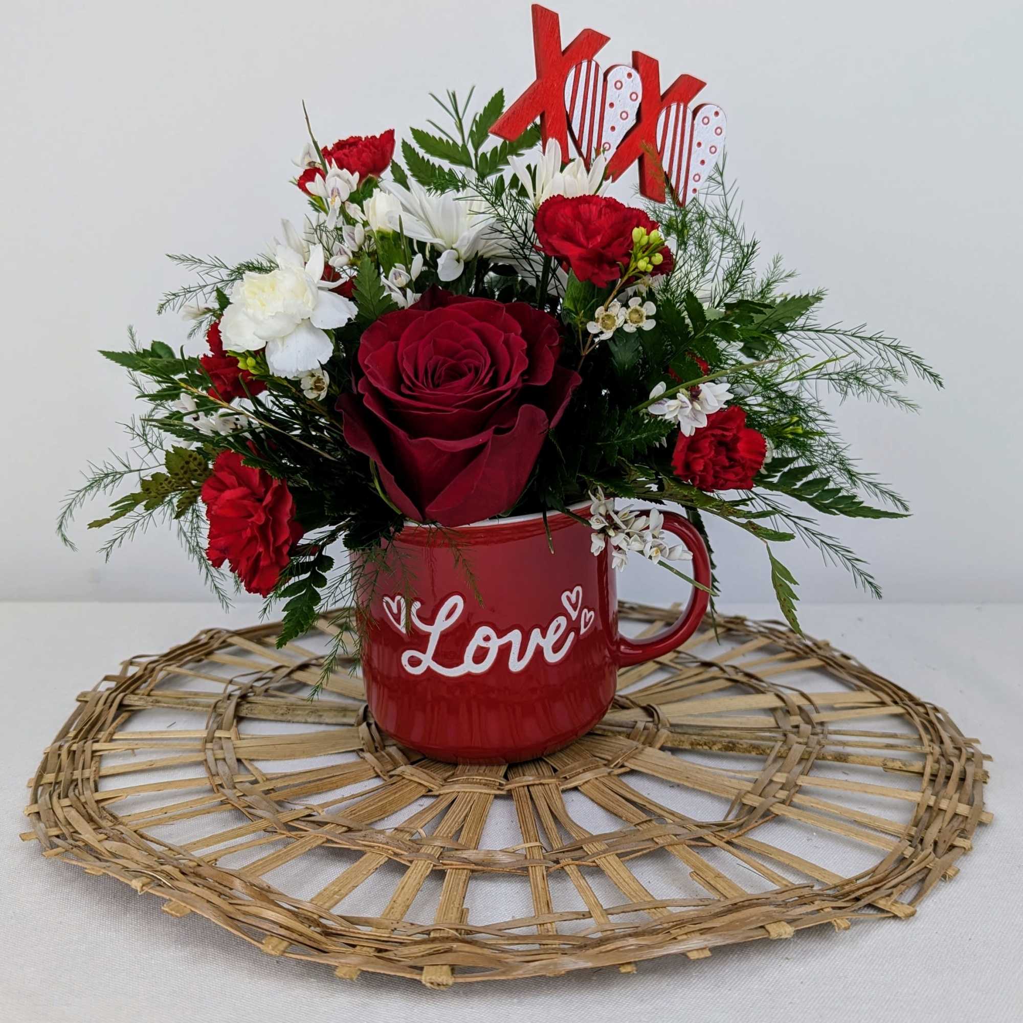 A cute love mug full of valentine flowers!