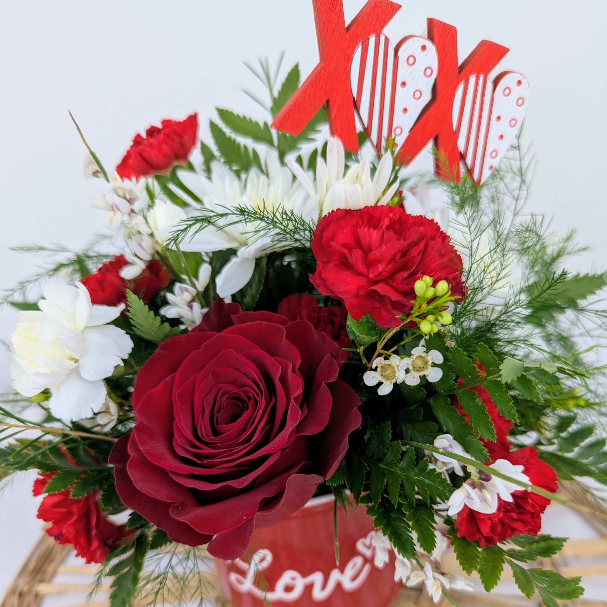 A cute love mug full of valentine flowers!