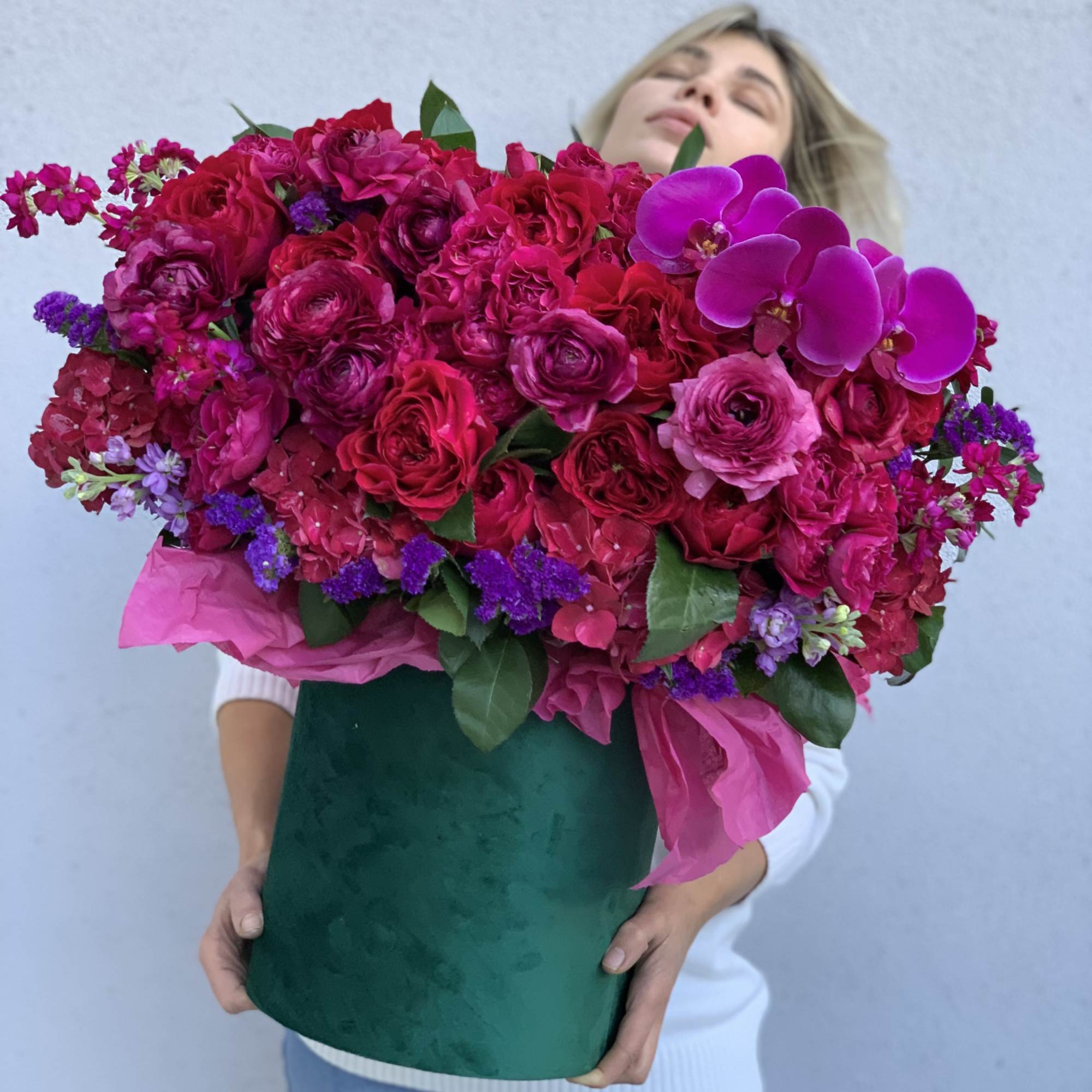 Gorgeous flowers of ripe cherry color and burgundy wine in an emerald