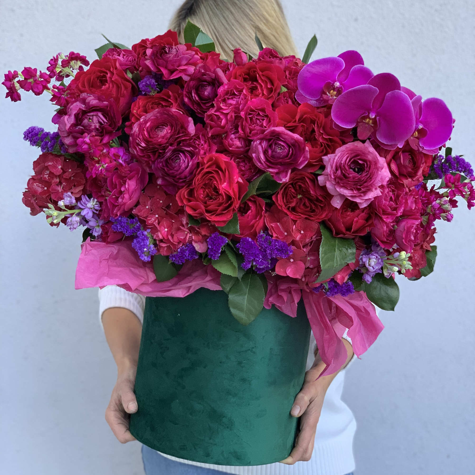 Gorgeous flowers of ripe cherry color and burgundy wine in an emerald