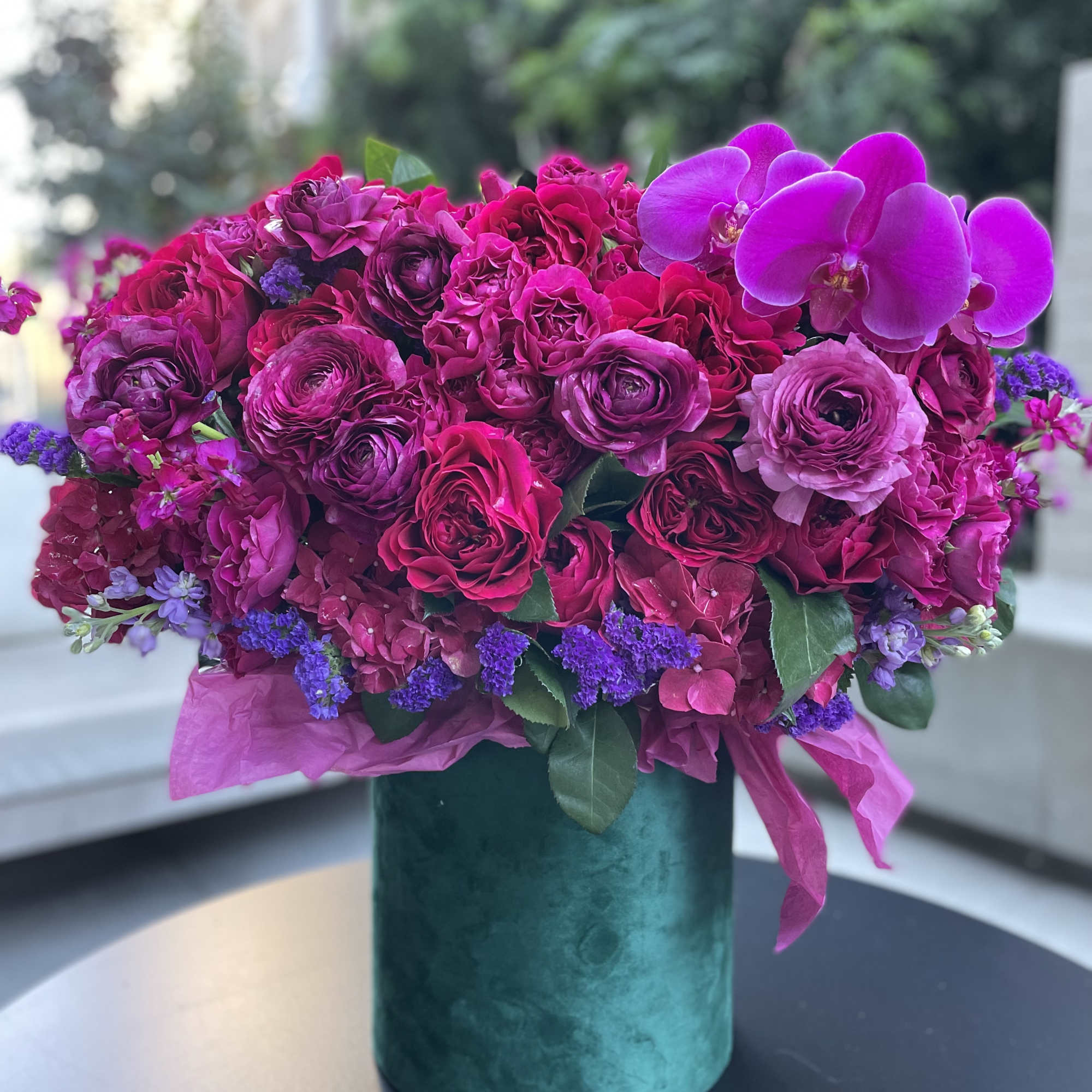 Gorgeous flowers of ripe cherry color and burgundy wine in an emerald