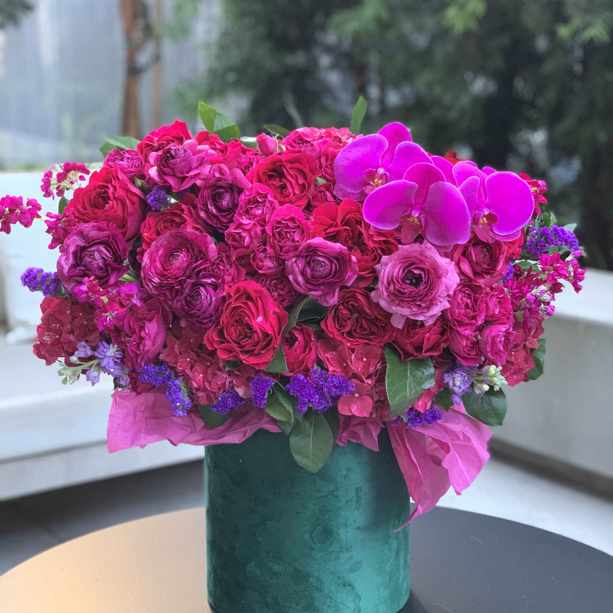 Gorgeous flowers of ripe cherry color and burgundy wine in an emerald