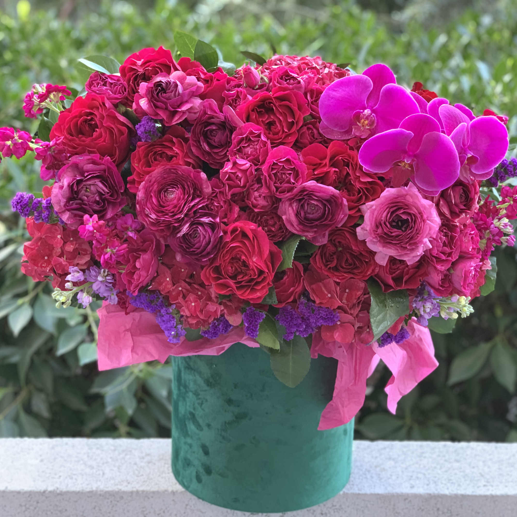 Gorgeous flowers of ripe cherry color and burgundy wine in an emerald