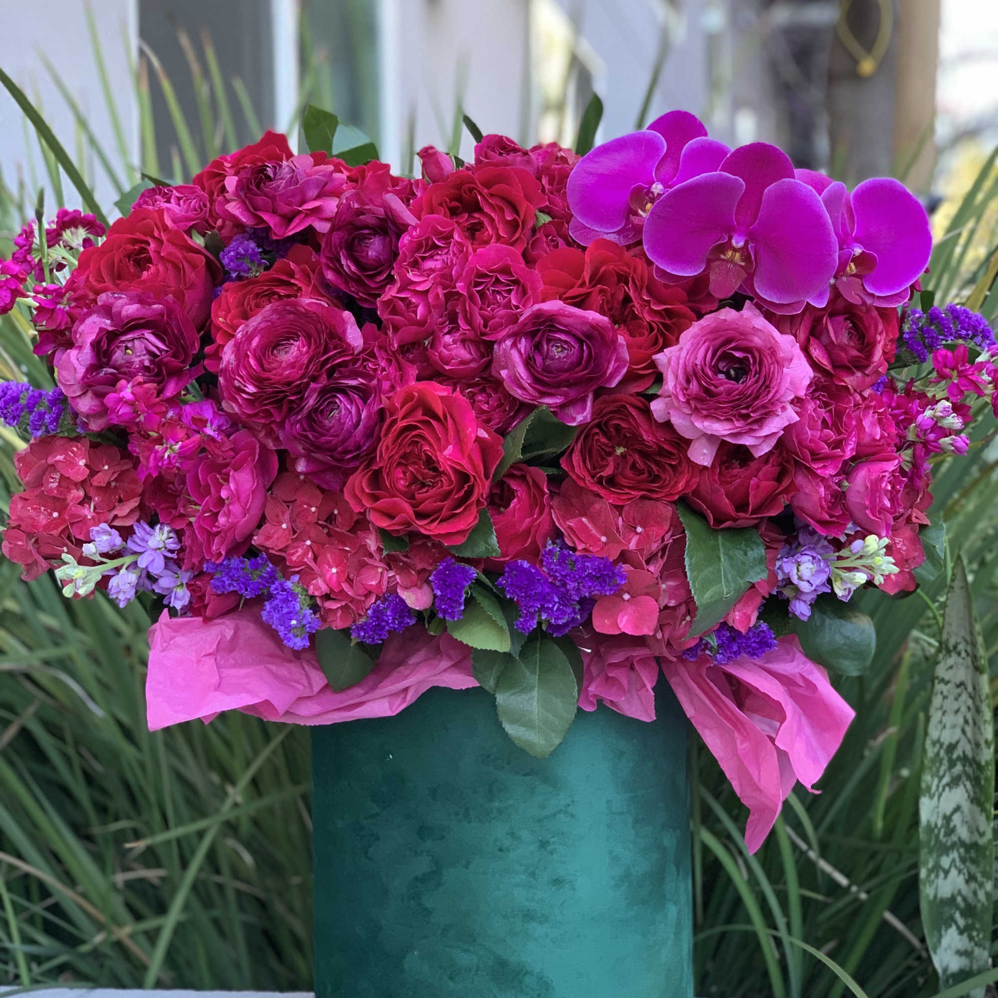 Gorgeous flowers of ripe cherry color and burgundy wine in an emerald