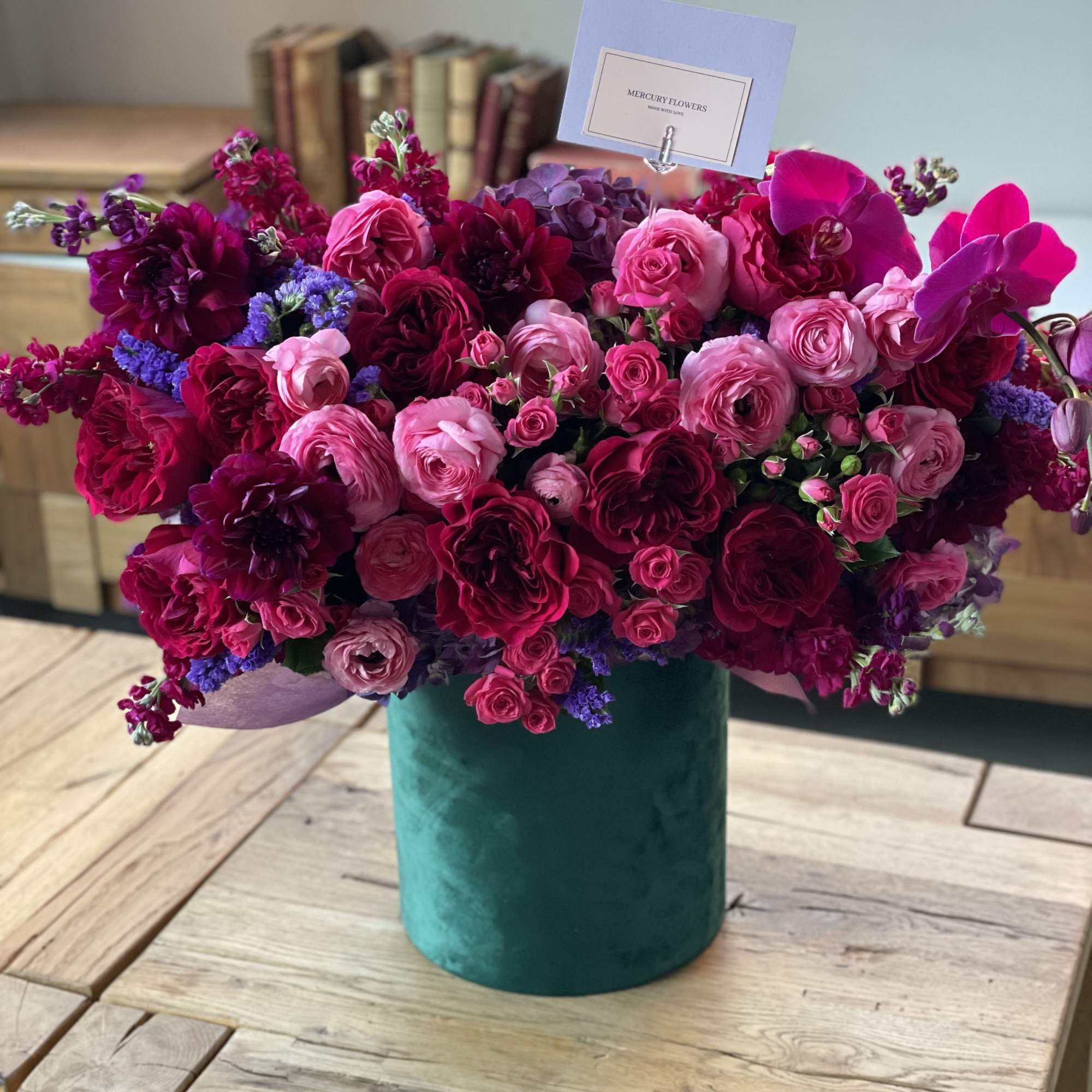 Gorgeous flowers of ripe cherry color and burgundy wine in an emerald