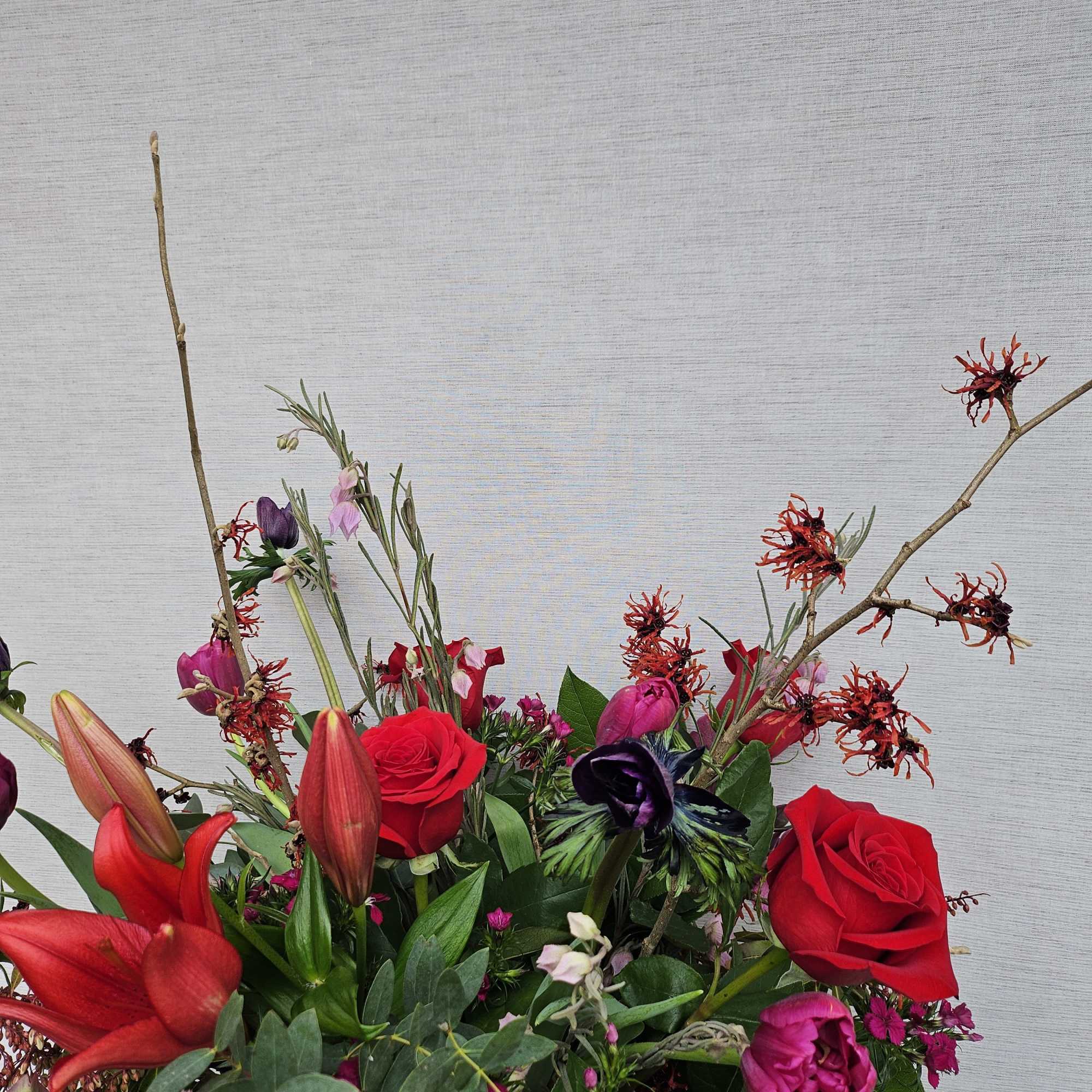 Bold &amp; bright seasonal mixed blooms
Shown here: lilies, roses, anemones, tulips, witchhazel...

***Please