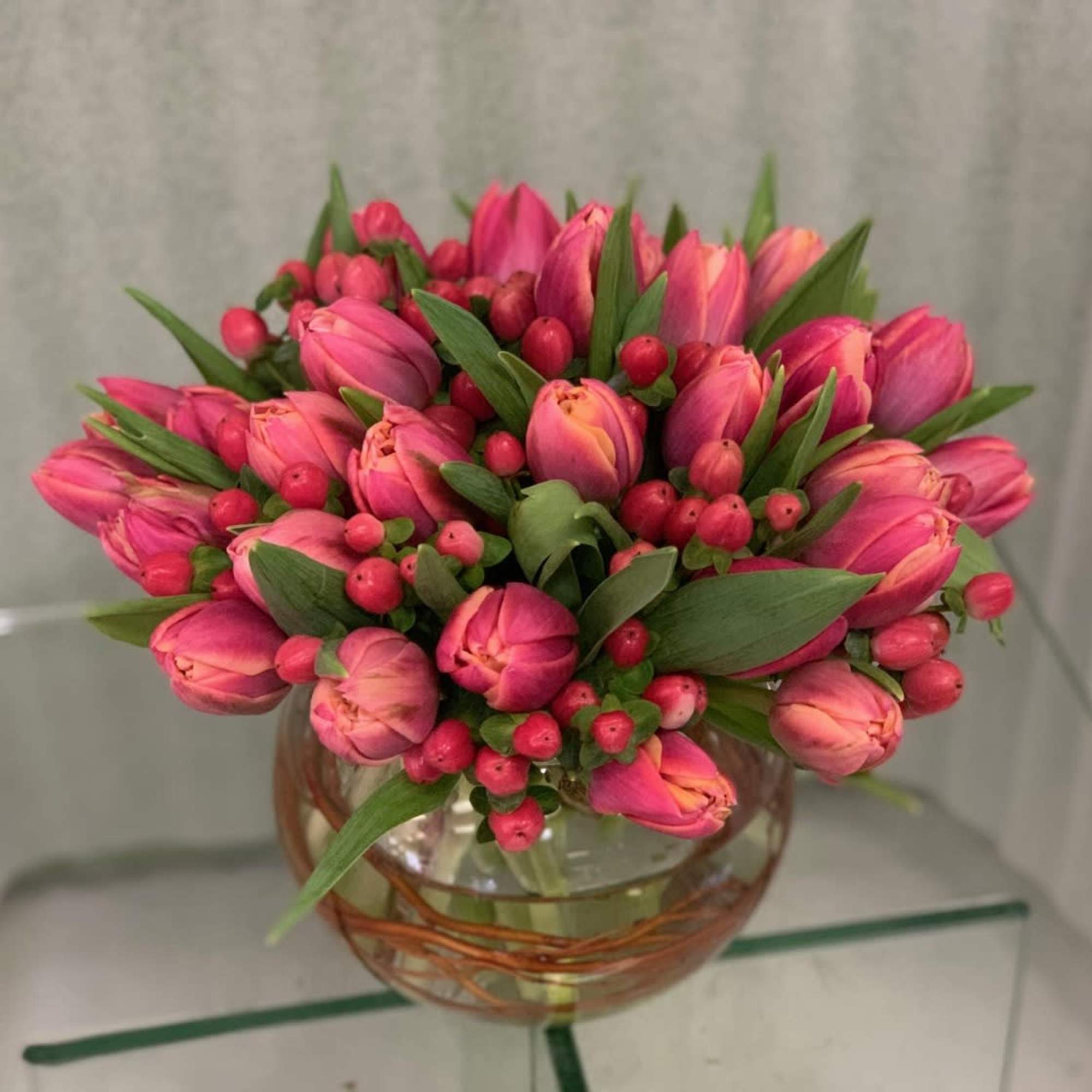 Hand-tied cluster of double tulips in a short bowl, cube or cylinder